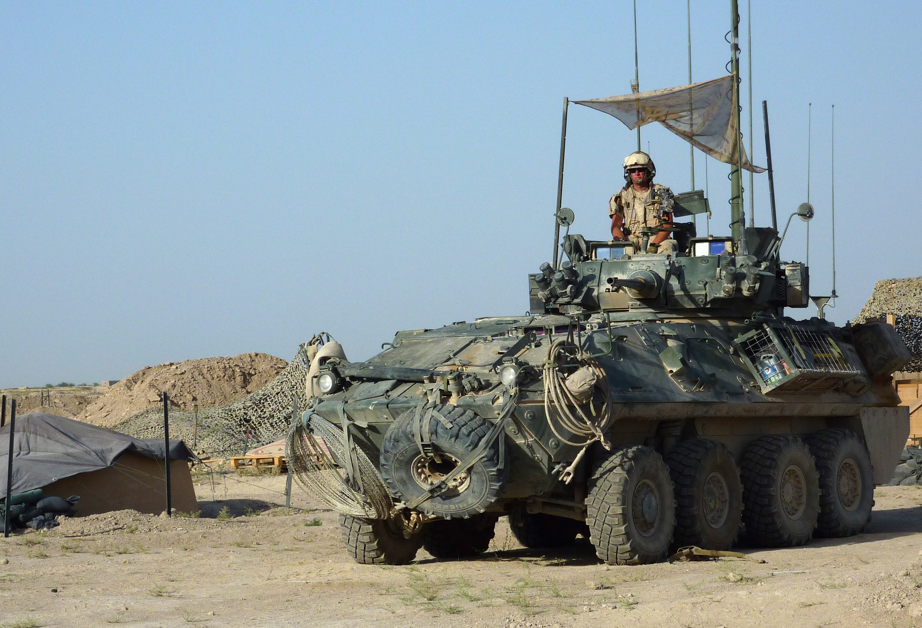 TO GO WITH Afghanistan-Canada-unrest-water FOCUS by Mike Patterson In a picture taken on July 10, 2010 a soldier from a reconnaissance squadron of the 1st Royal Canadian Regiment Battle Group keeps watch from a light armoured vehicle (LAV) at an observation post in the Panjwayi district of Kandahar province. Watching for Taliban insurgents attempting to plant roadside bombs in the district, the troops warn local farmers not to work close to the road in case they are mistaken for militants. AFP PHOTO/MIKE PATTERSON (Photo credit should read MIKE PATTERSON/AFP via Getty Images)
