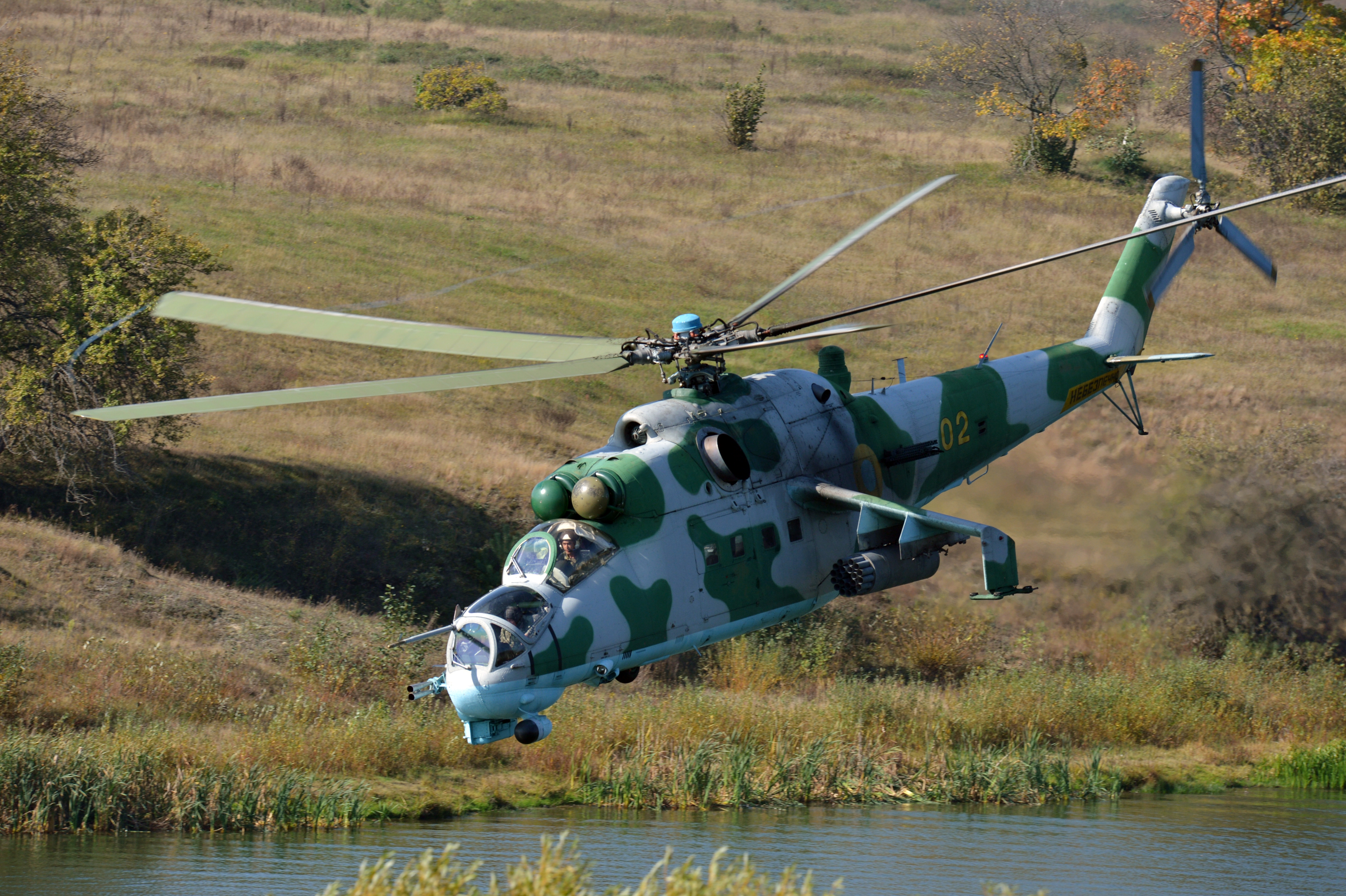 A Russian made Mi-24 or Hind Ukraine army helicopter performs an attack during military exercises dubbed Perspekyiva-2012 (Perspective-2012) near the city of Ghytomyr, some 170 km from Kiev, on September 27, 2012. About 900 soldiers and 145 vehicles including tanks, helicopters, planes and others took part in experimental special tactical training with live fire. AFP PHOTO/ SERGEI SUPINSKY (Photo credit should read SERGEI SUPINSKY/AFP/GettyImages)
