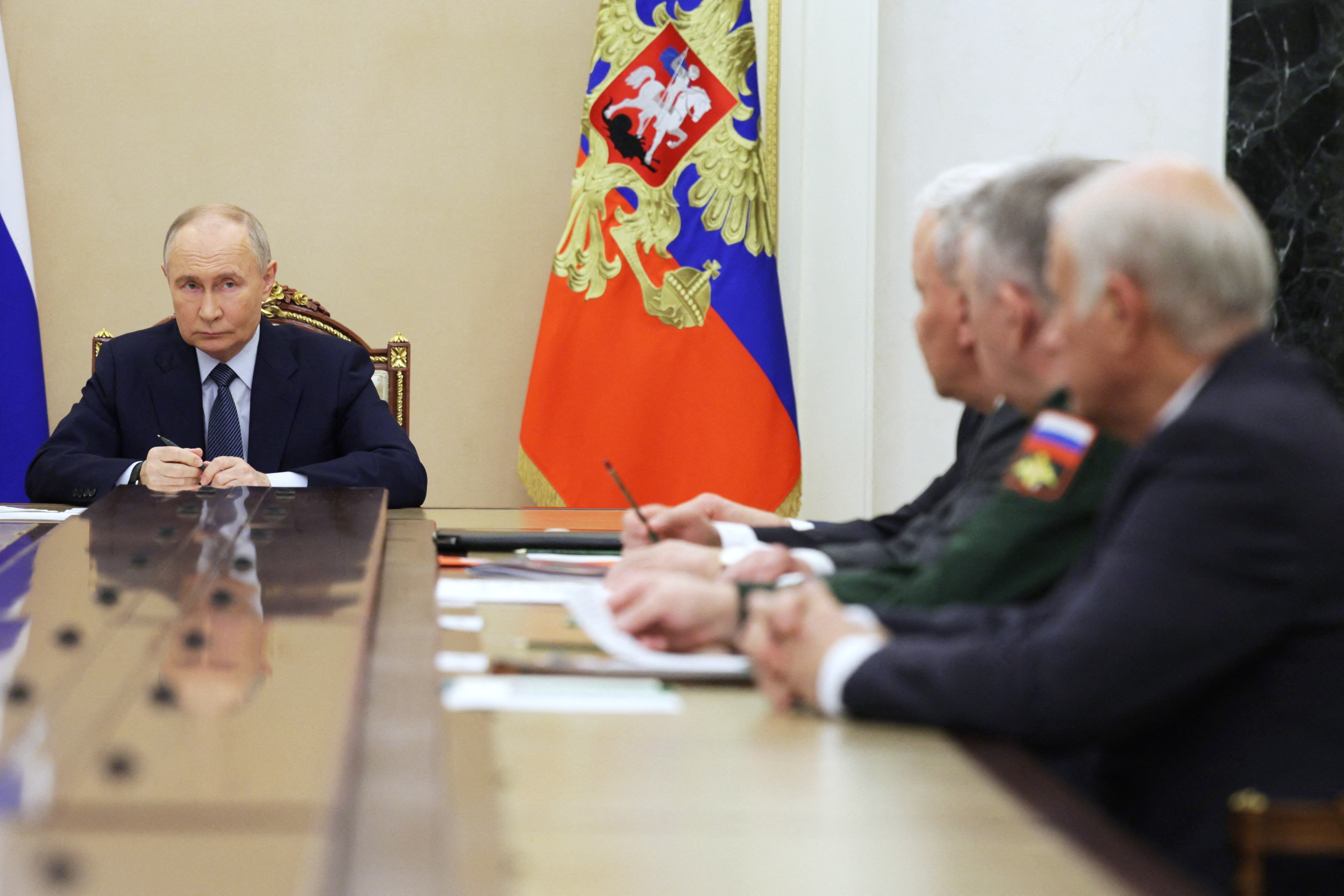 In this pool photograph distributed by the Russian state agency Sputnik, Russia's President Vladimir Putin meets with military chiefs in Moscow on November 22, 2024. Russian President Vladimir Putin said on November 22, 2024 that Moscow would carry out more tests of the hypersonic Oreshnik ballistic missile in "combat conditions," a day after firing one on Ukraine. (Photo by Gavriil GRIGOROV / POOL / AFP) (Photo by GAVRIIL GRIGOROV/POOL/AFP via Getty Images)