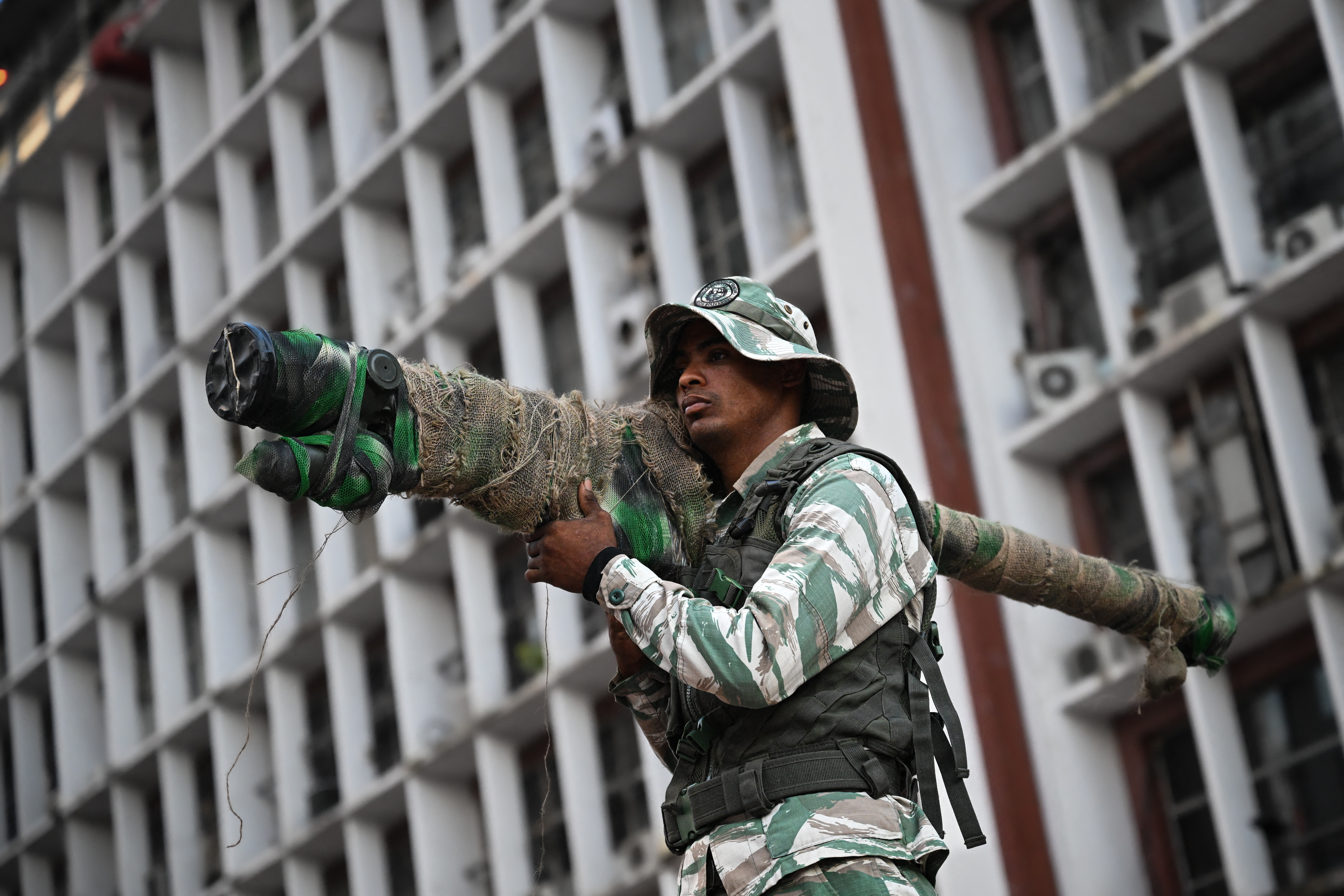 A member of the Bolivarian National Militia holds a Russian-made 9K338 "Igla-S" (SA-18) man-portable air-defense (MANPAD) surface-to-air missile launcher as he takes part in a rally against US military activity in the Caribbean, in Caracas on October 30, 2025. A US guided-missile destroyer that docked for four days in Trinidad and Tobago, within firing range of mainland Venezuela -- which called its presence a "provocation" -- departed as scheduled on Thursday, AFP witnessed. (Photo by Federico PARRA / AFP) (Photo by FEDERICO PARRA/AFP via Getty Images)