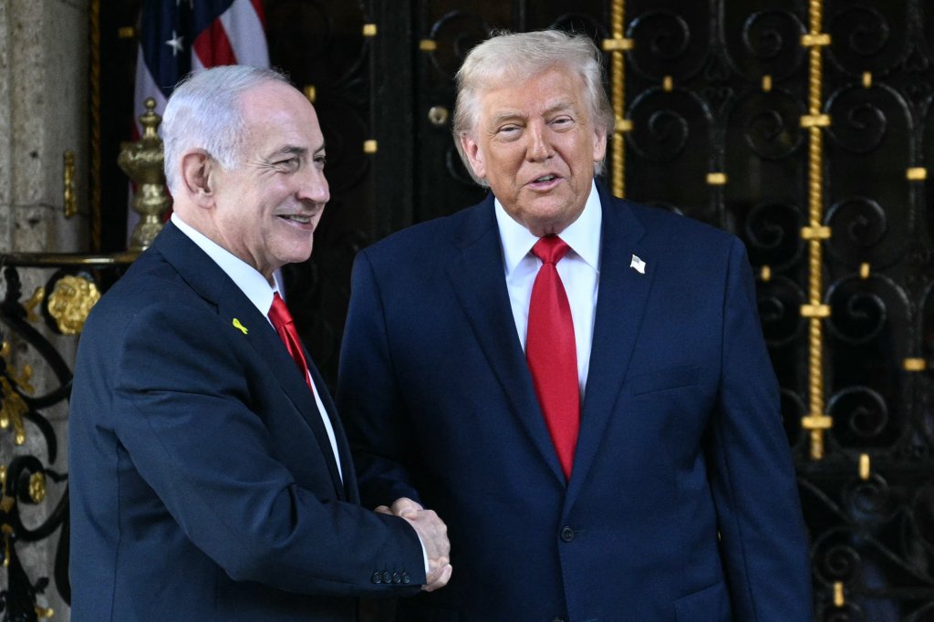 US President Donald Trump (R) greets Israeli Prime Minister Benjamin Netanyahu (L) upon arrival at Trump's Mar-a-Lago residence in Palm Beach, Florida, on December 29, 2025. (Photo by Jim WATSON / AFP via Getty Images)