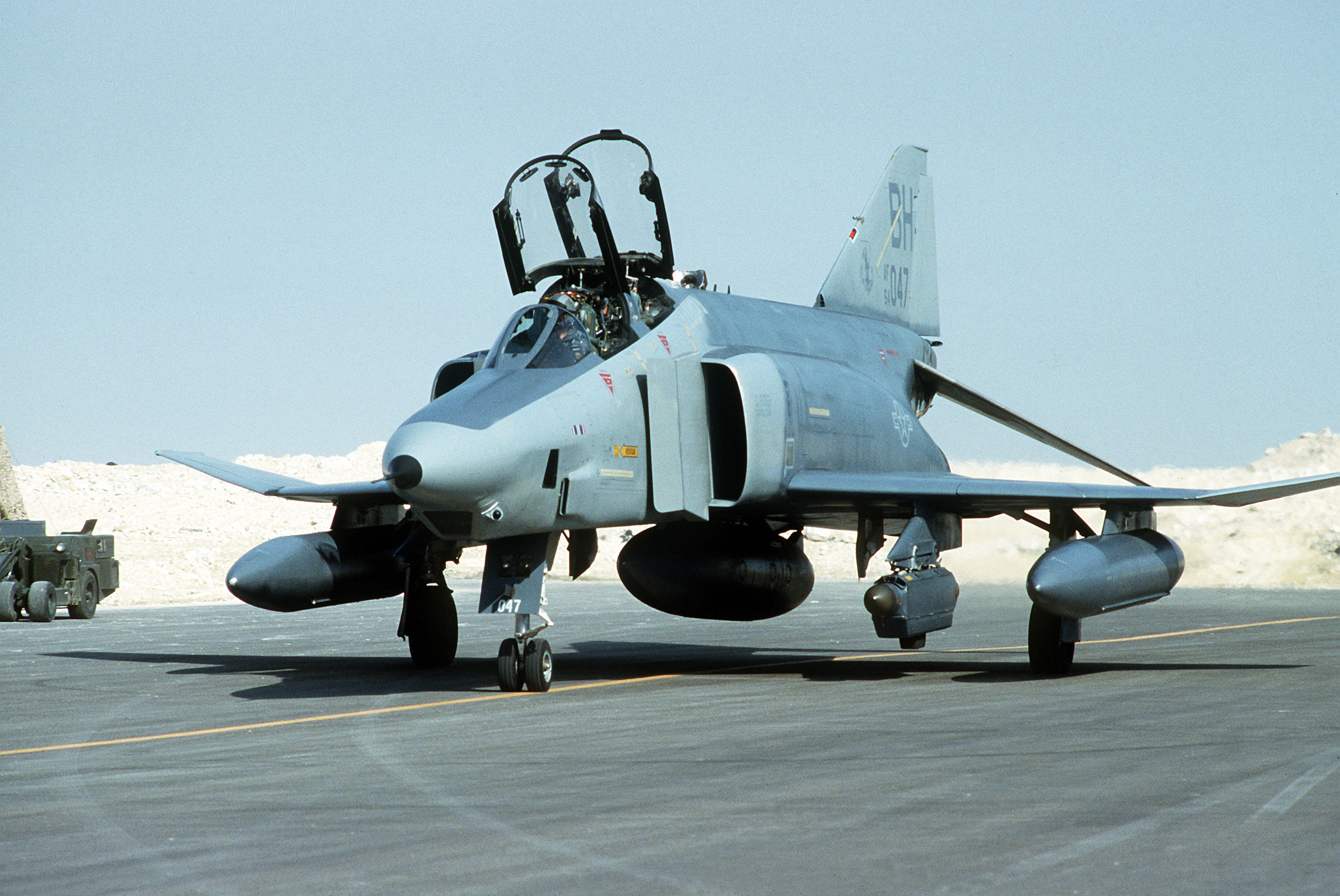 An RF-4C Phantom II reconnaissance aircraft of the 117th Tactical Reconnaissance Wing is parked at an air field following a mission on the first day of Operation Desert Storm.