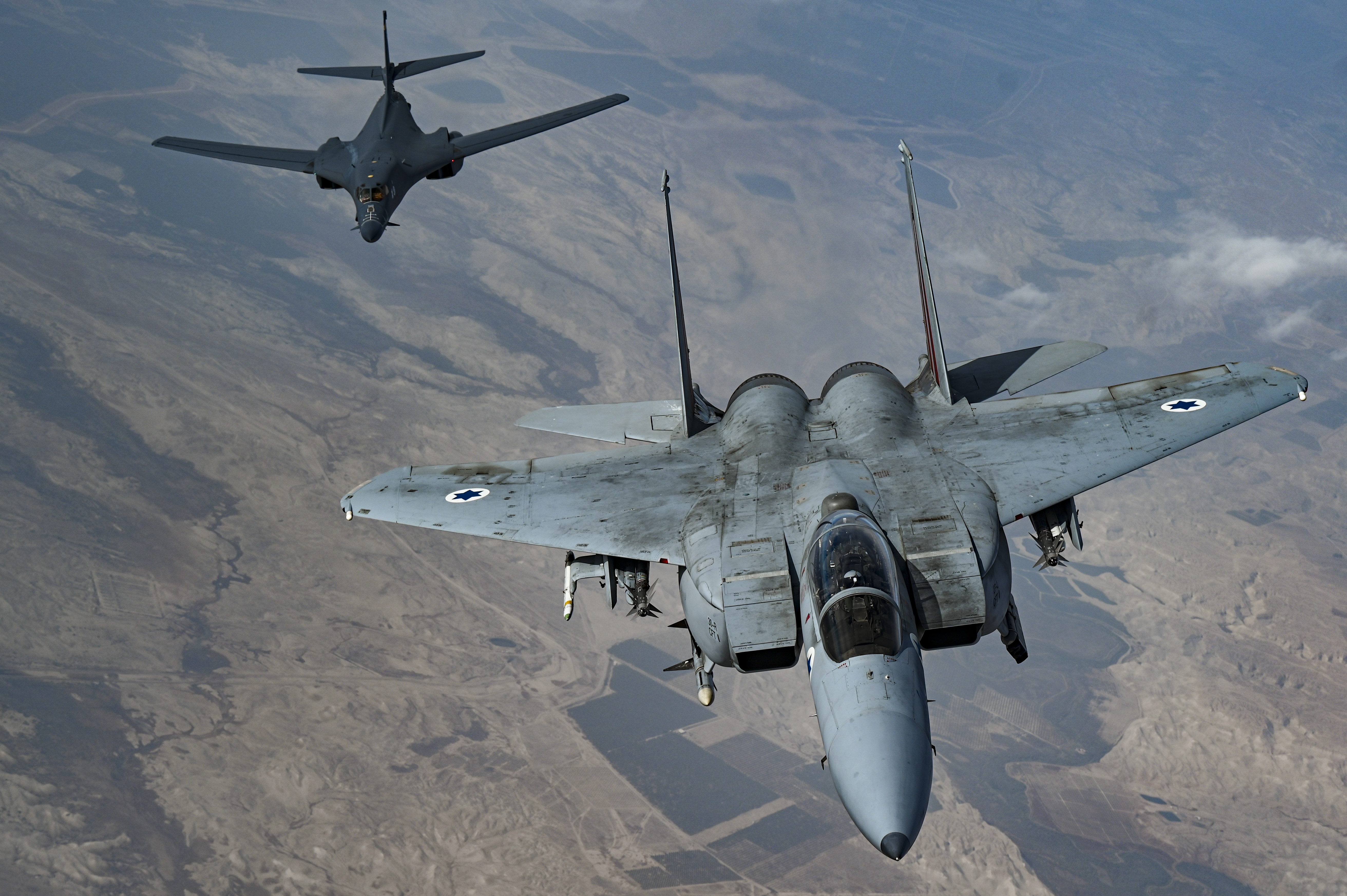 An Israeli Air Force F-15 Strike Eagle moves into formation with a U.S. Air Force B-1B Lancer over Israel as part of a presence patrol above the U.S. Central Command’s area of responsibility Oct. 30, 2021. Multiple partner nations’ fighter aircraft accompanied the B-1B Lancer at different points during the flight, which flew over the Gulf of Aden, Bab el-Mandeb Strait, Red Sea, Suez Canal, Arabian Gulf, Strait of Hormuz and the Gulf of Oman before departing the region. (U.S. Air Force photo by Senior Airman Jerreht Harris)