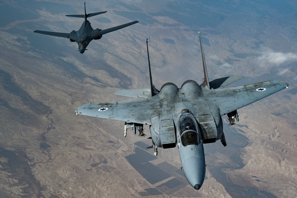 An Israeli Air Force F-15 Strike Eagle moves into formation with a U.S. Air Force B-1B Lancer over Israel as part of a presence patrol above the U.S. Central Command’s area of responsibility Oct. 30, 2021. Multiple partner nations’ fighter aircraft accompanied the B-1B Lancer at different points during the flight, which flew over the Gulf of Aden, Bab el-Mandeb Strait, Red Sea, Suez Canal, Arabian Gulf, Strait of Hormuz and the Gulf of Oman before departing the region. (U.S. Air Force photo by Senior Airman Jerreht Harris)