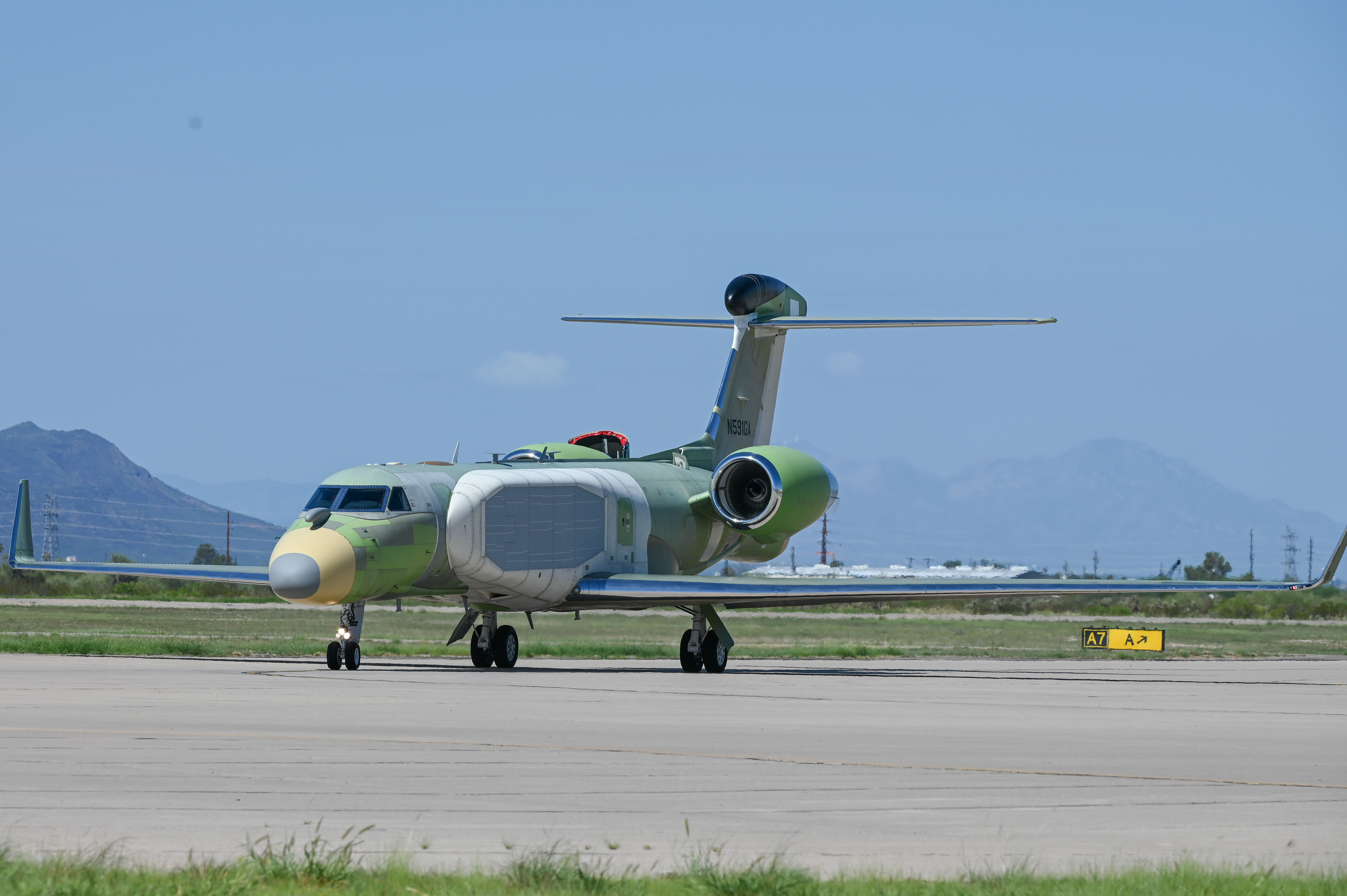 An EC-37B Compass Call arrives at Davis-Monthan Air Force Base, Arizona, Aug. 17, 2022. Compass Call suppresses air defenses by preventing the transmission of essential information between adversaries, their weapon systems, and control networks. (U.S. Air Force photo by Airman 1st Class Vaughn Weber)