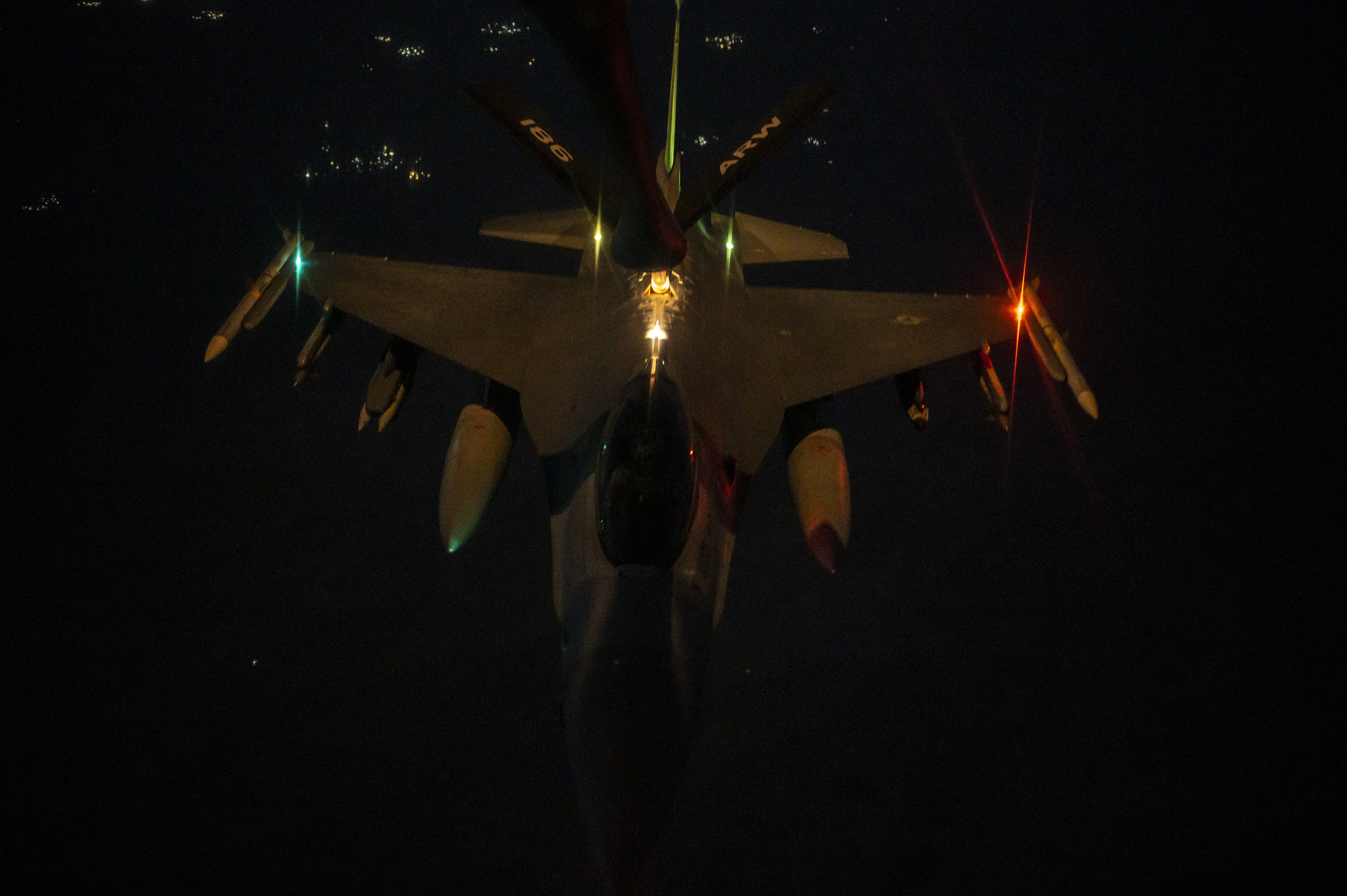 A U.S. Air Force F-16 Fighting Falcon conducts night time air refueling operations above the U.S. Central Command area of responsibility, June 26, 2023. The KC-135 Stratotanker allows air assets to significantly increase flight time and decrease time spent on the ground. (U.S. Air Force photo by Senior Airman Jacob Cabanero)