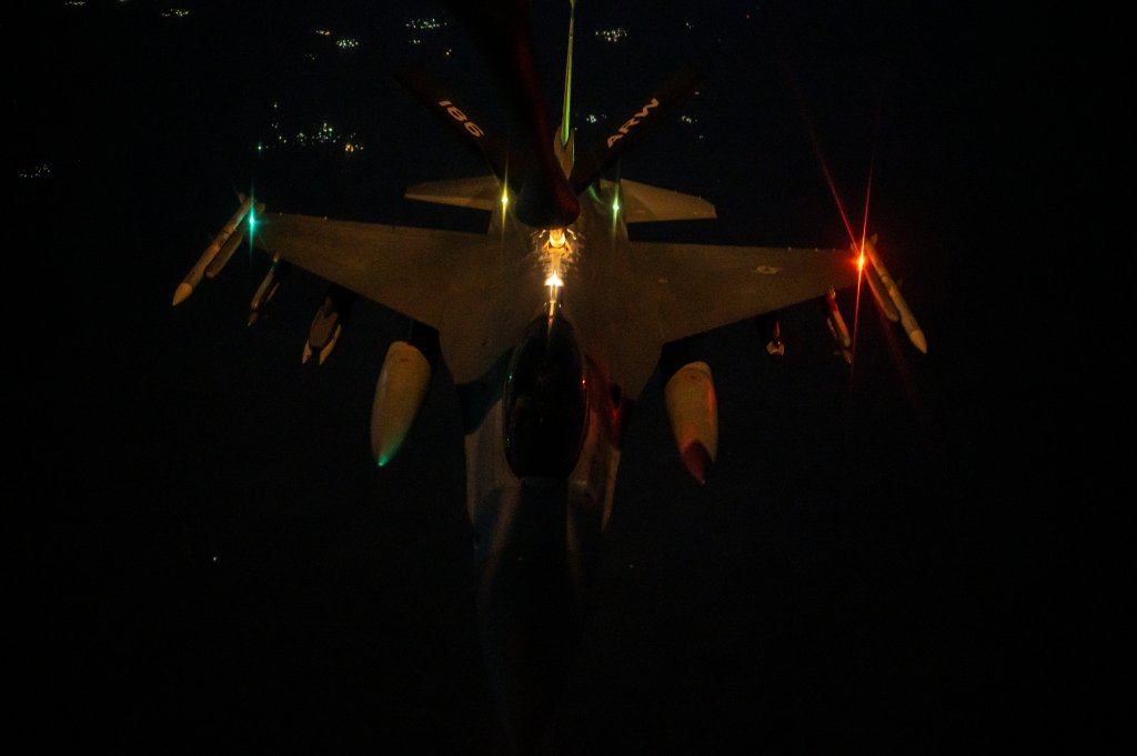 A U.S. Air Force F-16 Fighting Falcon conducts night time air refueling operations above the U.S. Central Command area of responsibility, June 26, 2023. The KC-135 Stratotanker allows air assets to significantly increase flight time and decrease time spent on the ground. (U.S. Air Force photo by Senior Airman Jacob Cabanero)