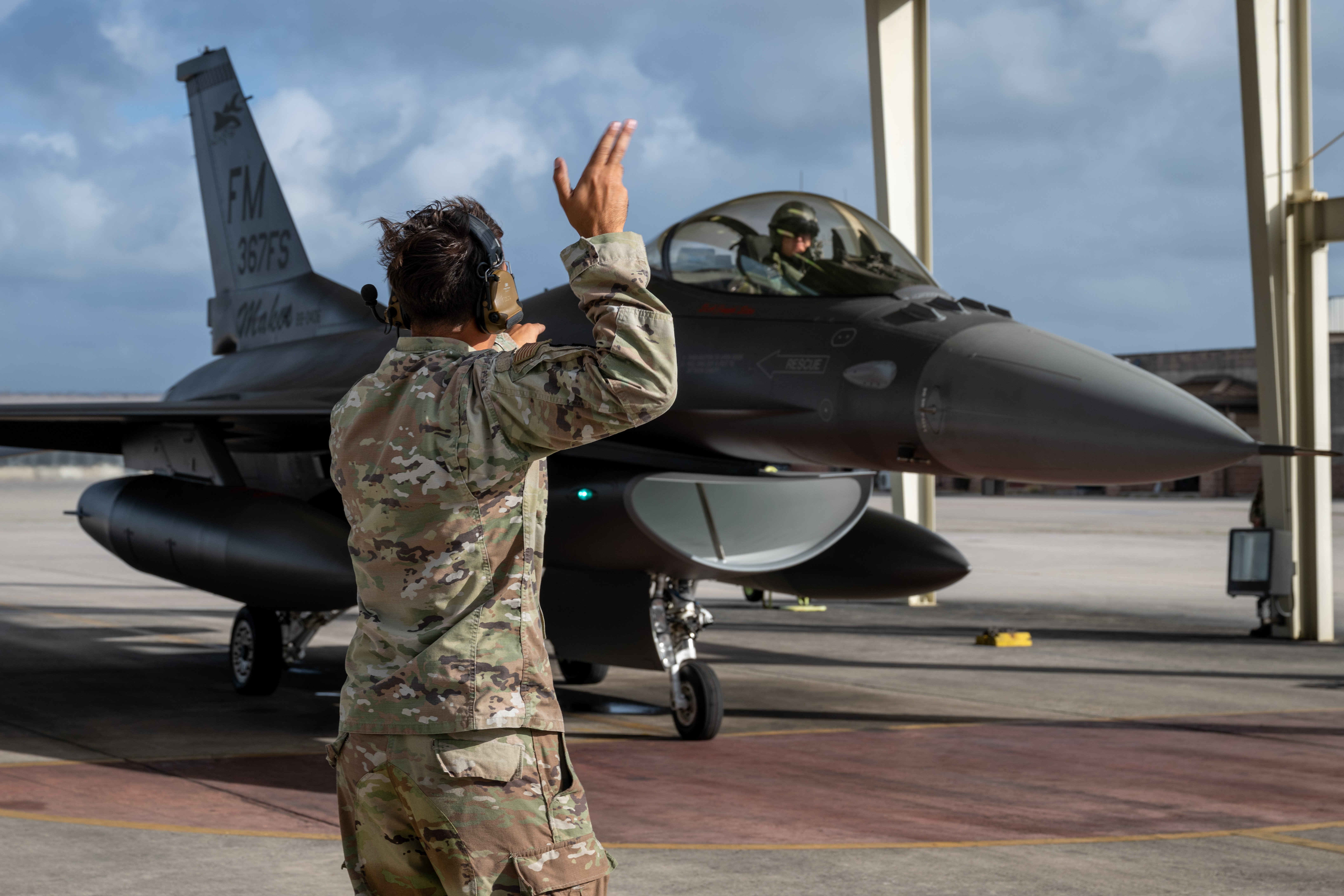 Senior Airman Brandon Azocar, a crew chief assigned to the 482d Maintenance Squadron, marshals out an F-16 Fighting Falcon before its inaugural flight with the “367FS” tail flash at Homestead Air Reserve Base, Fla., April 4, 2025. Azocar launched the aircraft, piloted by Lt. Col. Dysart Cleeton, 367th Fighter Squadron commander. (U.S. Air Force photo by Master Sgt. Lionel Castellano)