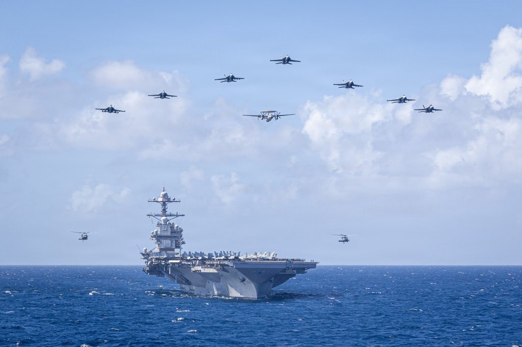 U.S. Navy Carrier Air Wing 8 aircraft fly in formation over the world’s largest aircraft carrier, Ford-class aircraft carrier USS Gerald R. Ford (CVN 78), during Carrier Air Wing 8’s aerial change of command ceremony while underway in the Caribbean Sea, Jan. 19, 2026. U.S. military forces are deployed to the Caribbean in support of the U.S. Southern Command mission, Department of War-directed operations, and the president’s priorities to disrupt illicit drug trafficking and protect the homeland. (U.S. Navy photo)