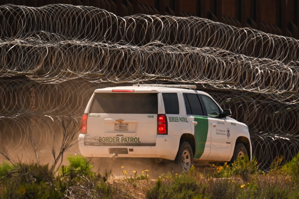A US Customs and Border Protection (CBP) Border Patrol vehicle drives past recently installed concertina wire on a section of border wall fencing along the US-Mexico border between San Diego and Tijuana in San Diego, California on April 24, 2025. (Photo by Patrick T. Fallon / AFP) (Photo by PATRICK T. FALLON/AFP via Getty Images)