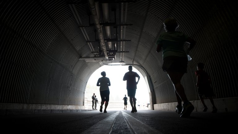 CHEYENNE MOUNTAIN AIR FORCE STATION, Colo.—Runners participating in the North American Aerospace Defense Command 5k Tunnel Run exit the Cheyenne Mountain Complex through the north portal at Cheyenne Mountain Air Force Station, Colorado, May 10, 2018. The run was open to all local military personnel, friends and family and was held to celebrate the 60th Anniversary of NORAD and the U.S. Canadian binational NORAD agreement.. (U.S. Air Force photo by Senior Airman Dennis Hoffman)