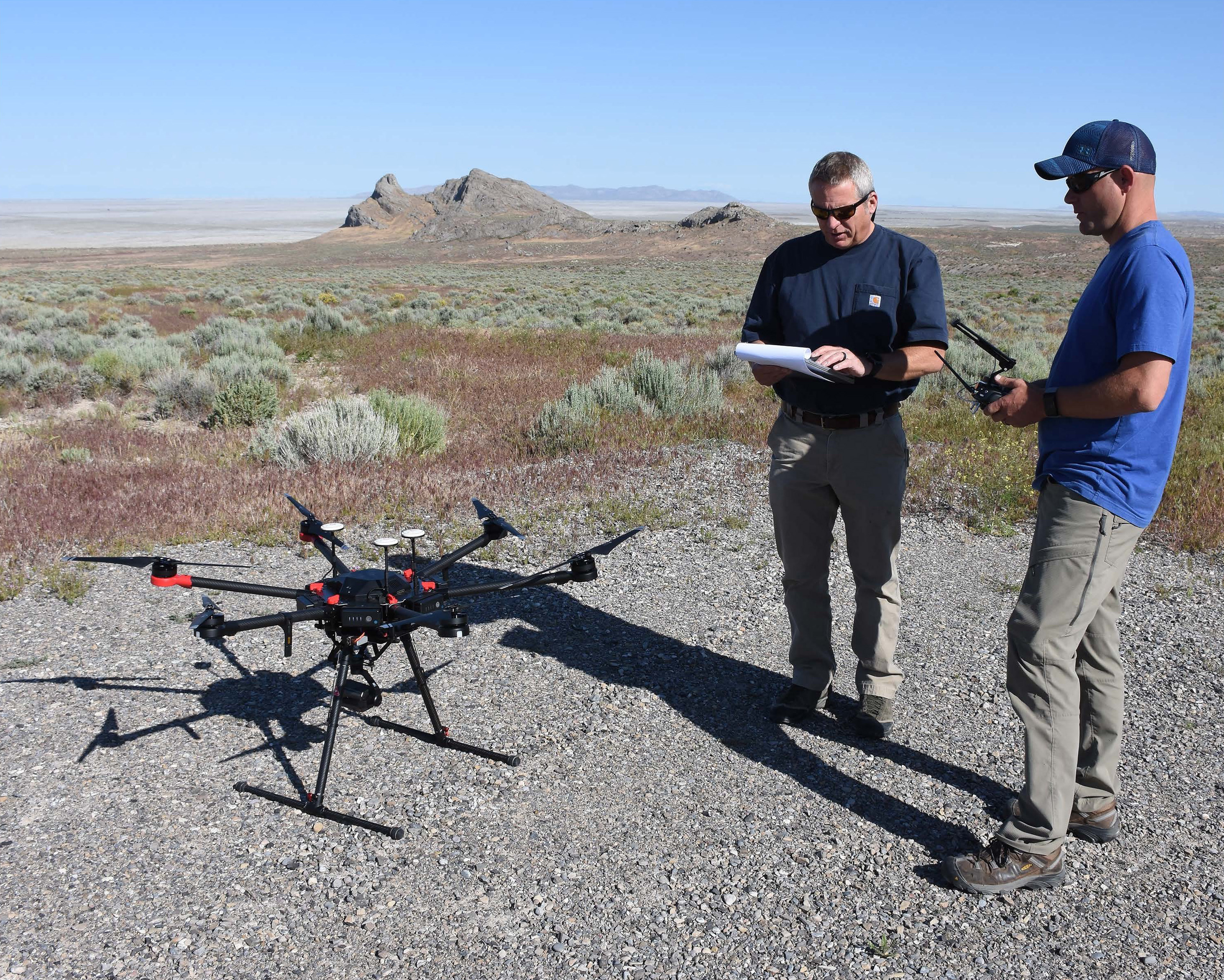 Project team members prepare to launch a small unmanned aircraft system (sUAS) to observe golden eagle nests on Dugway Proving Ground. The nests were observed for two years using three platforms to determine the strengths and weaknesses of each method. Dugway Proving Ground photo.