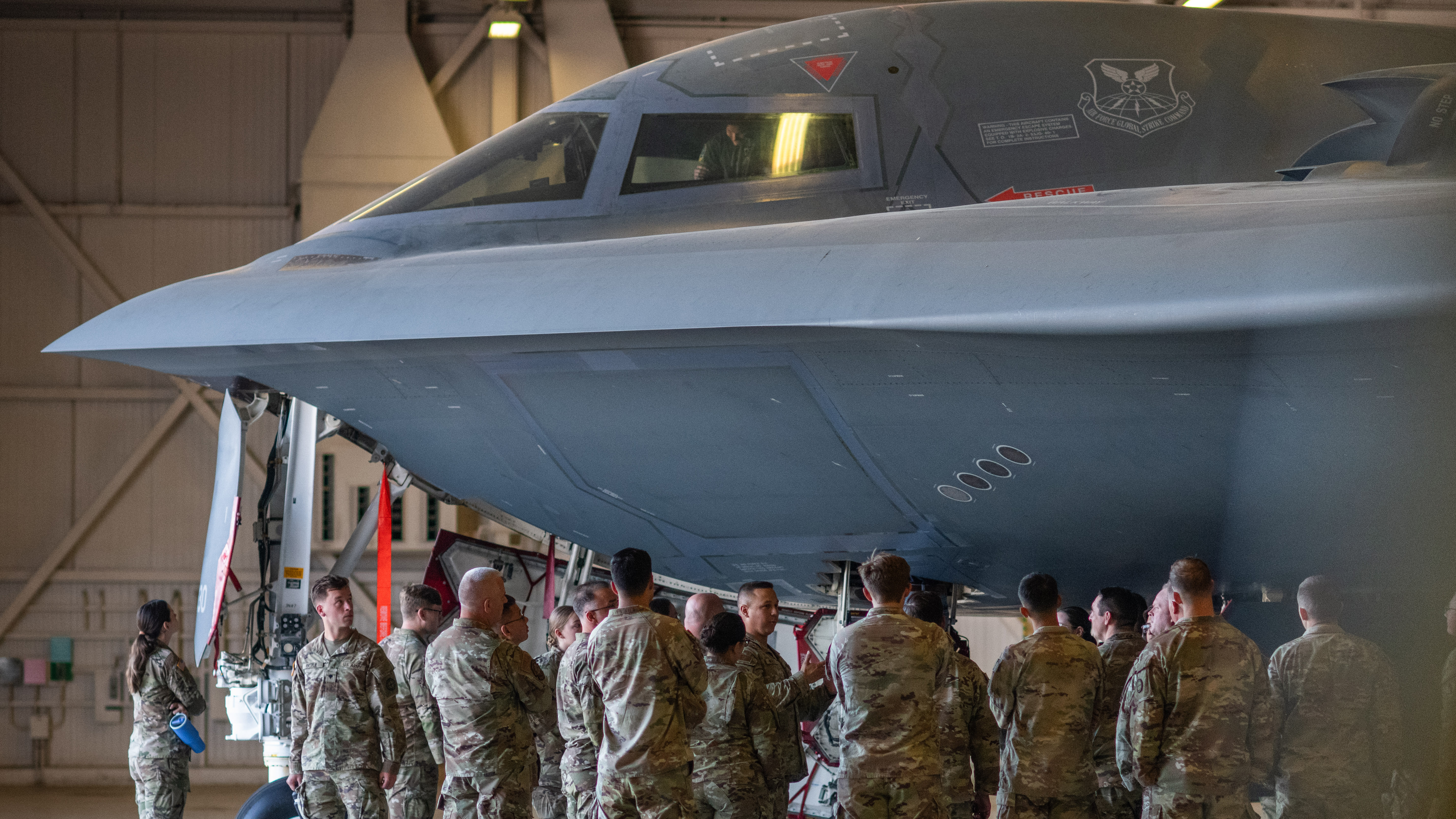 Joint military intelligence Airmen and Soldiers from the Missouri National Guard tour a B-2 Spirit stealth bomber during the 2025 MONG J2 Joint Intel Symposium at Whiteman Air Force Base, Missouri, Sept. 7, 2025. Servicemembers attending the symposium shared perspectives on the complexity of tomorrow's threat environment with senior Missouri National Guard leadership. (U.S. Air National Guard photo by 2nd Lt. Chris Bishop)