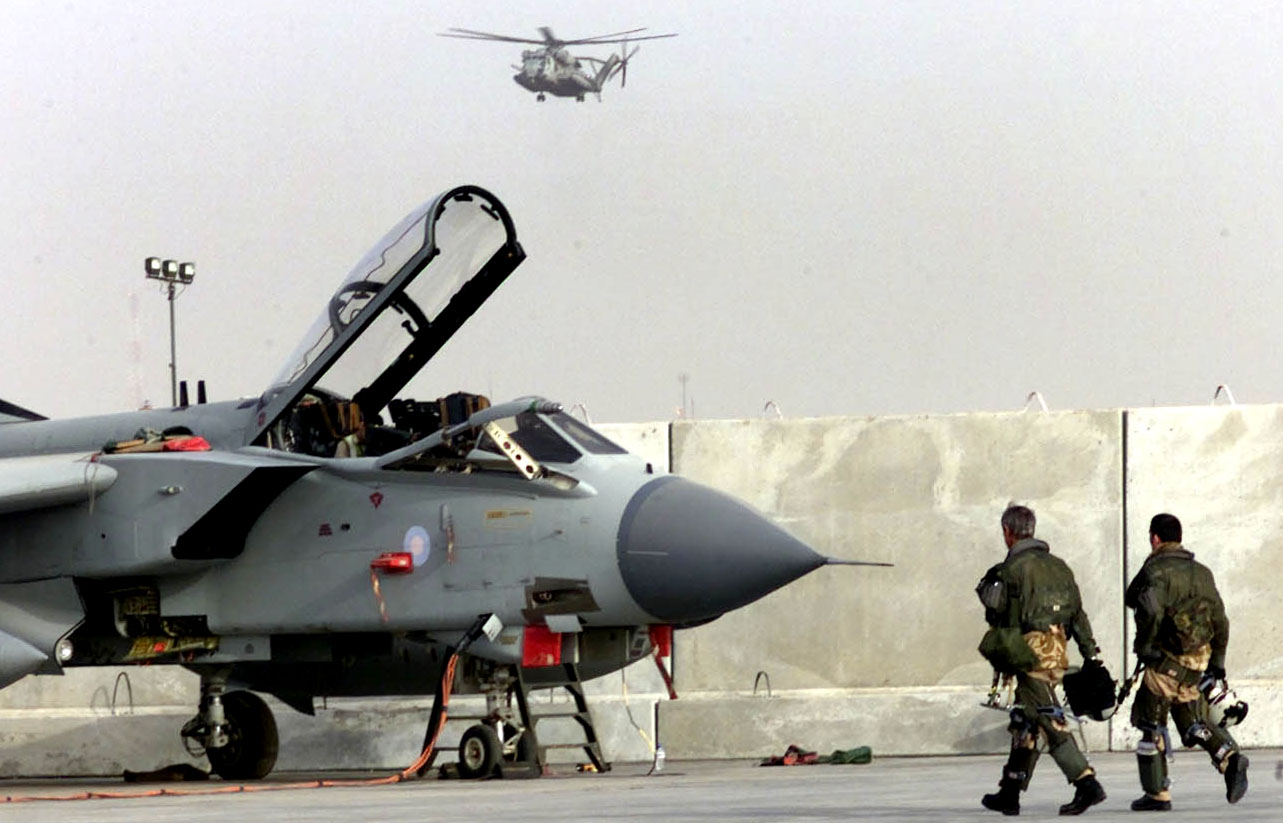 KUWAIT - FEBRUARY 26: British Royal Airforce (RAF) pilots from 617 Squadron walk to their Tornado GR4 fighter plane after a sortie over Southern Iraq February 26, 2003, near Kuwait City. U.S. President George W. Bush has decided to seek a second UN Security Council endorsement to wage war on Iraq primarily to aid British Prime Minister Tony Blair, who faces opposition at home to his hawkish stance on Iraq. (Photo by Richard Pohle-Pool/Getty Images)