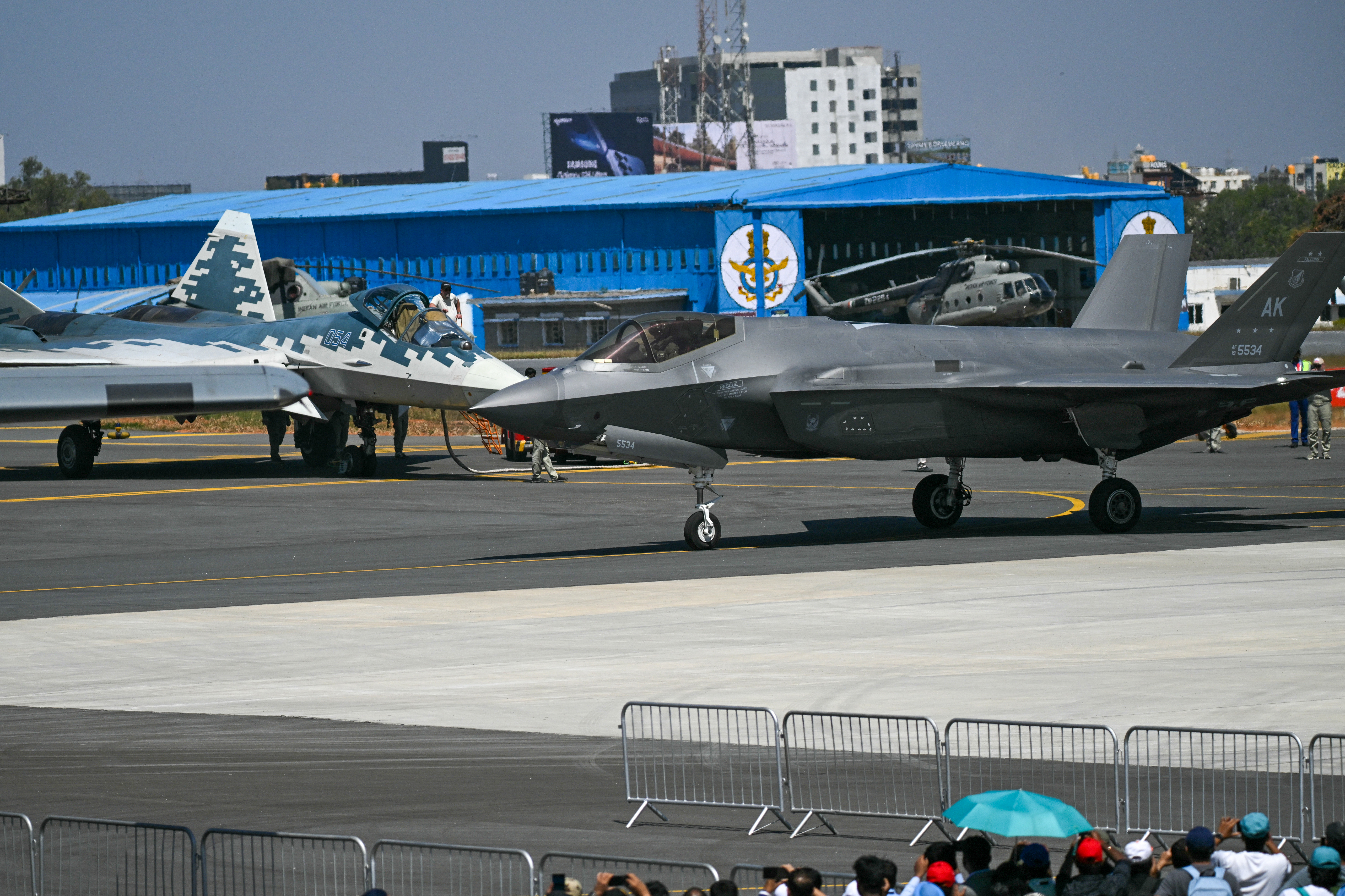 A Russian Sukhoi Su-57 (L) and U.S. Air Force's F-35 fifth-generation fighter aircrafts are pictured at the tarmac during Aero India 2025, a military aviation exhibition at the Yelahanka Air Force Station in Bengaluru on February 11, 2025. Air traffic is booming in India, even though only a tiny fraction of its people fly each year, and manufacturers are seeking lucrative deals at the flagship Aero India exhibition from February 10. (Photo by Arun SANKAR / AFP) (Photo by ARUN SANKAR/AFP via Getty Images)
