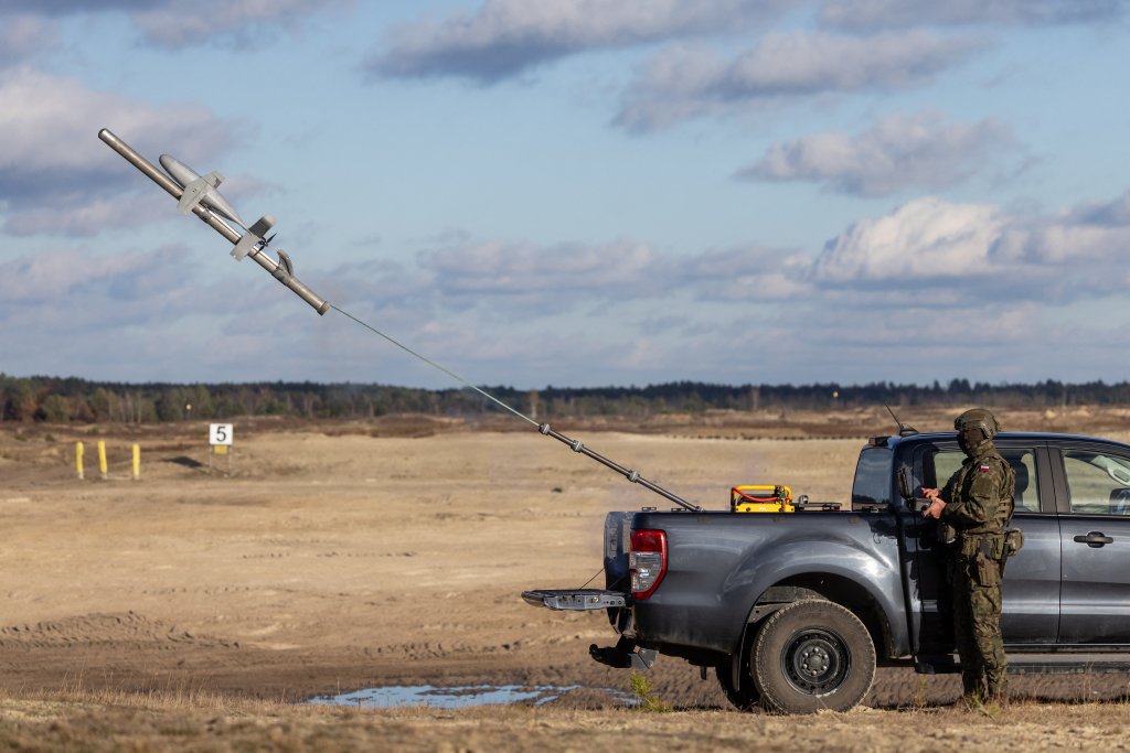 TOPSHOT - A Polish soldier is seen as he operates an interception drone of the American MEROPS counter drone system during tests at the Nowa Deba military training ground, south-eastern Poland, on November 18, 2025. (Photo by Wojtek RADWANSKI / AFP) (Photo by WOJTEK RADWANSKI/AFP via Getty Images)