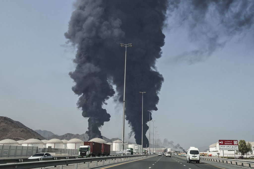 TOPSHOT - Smoke rises from the direction of an energy installation in the Gulf emirate of Fujairah on March 14, 2026. Smoke could be seen rising from the direction of a major UAE energy installation on March 14, in what appeared to be the latest strike targeting the Gulf's petroleum facilities hours after the US struck Iran's Kharg Island. (Photo by AFP via Getty Images) /