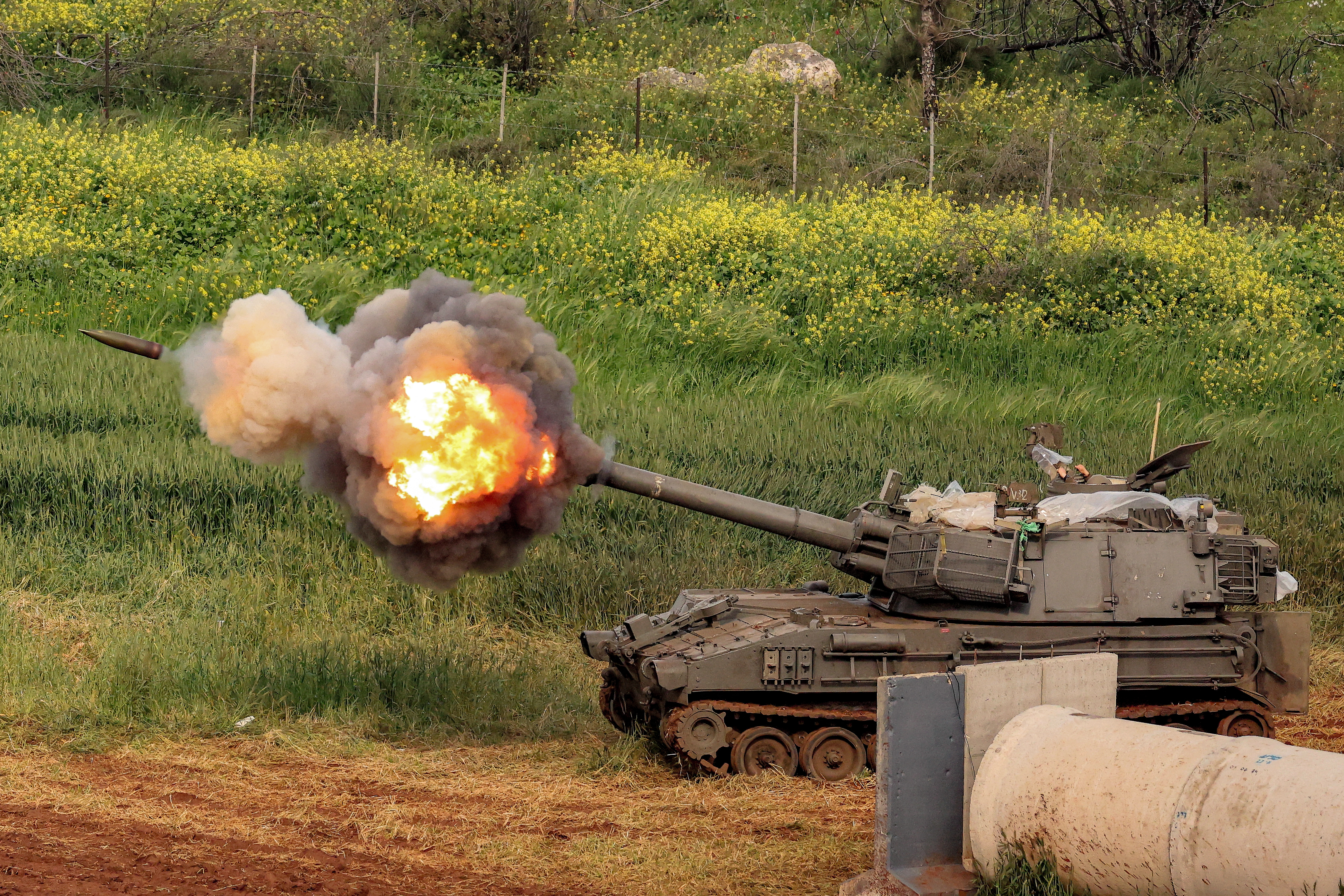 An Israeli self-propelled howitzer artillery gun fires rounds towards southern Lebanon from a position in the upper Galilee in northern Israel near the border on March 26, 2026. Lebanon was drawn into the Middle East war on March 2, when pro-Iran Hezbollah launched rockets towards Israel in response to US-Israeli strikes that killed Iranian supreme leader on February 28. (Photo by Jack GUEZ / AFP via Getty Images) /