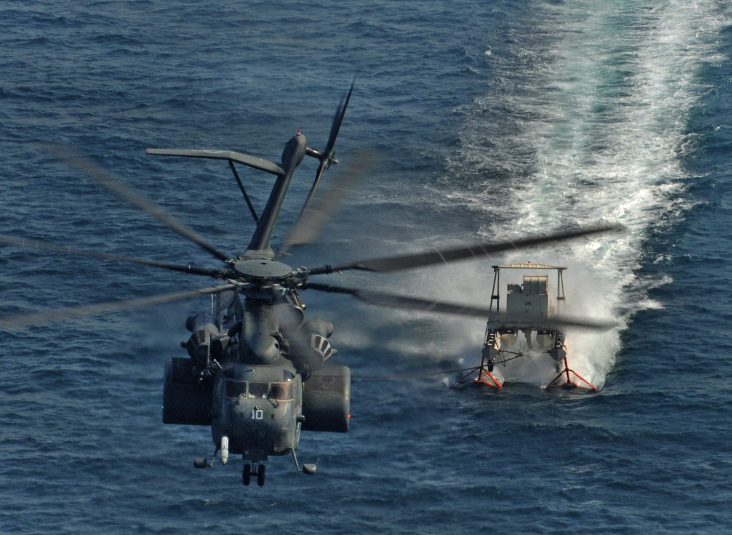 An MH-53E Sea Dragon from Helicopter Mine Countermeasure Squadron (HM) 15, aboard the multipurpose amphibious assault ship USS Wasp (LHD 1), performs Mine Countermeasure training using the MK-105 sled Nov. 12. Wasp is conducting Mine Countermeasure Exercises to demonstrate the U.S. Navy's ability to defend against mine-laying operations and ensure open access to sea lanes. (U.S. Navy photo/Lt. Cmdr. John L. Kline)