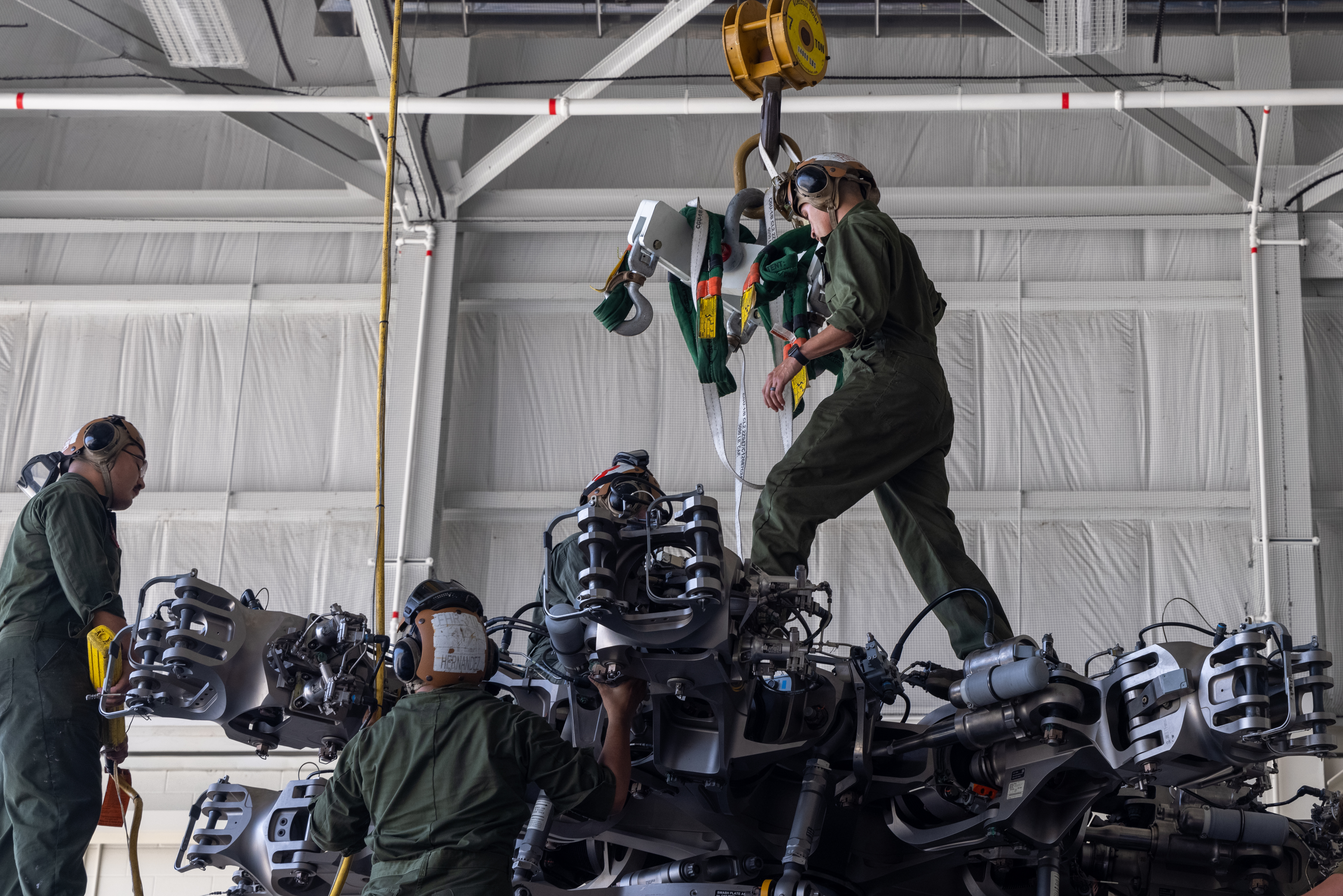U.S. Marines install an engine on a CH-53K King Stallion, assigned to Marine Operational Test and Evaluation Squadron One (VMX-1), on Marine Corps Air Station New River, North Carolina, July 7, 2022. The CH-53K was recently declared initial operating capable (IOC), a critical milestone in improving capabilities and restructuring Marine Corps aviation for the future fight. (U.S. Marine Corps photo by Lance Cpl. Joshua Crumback)