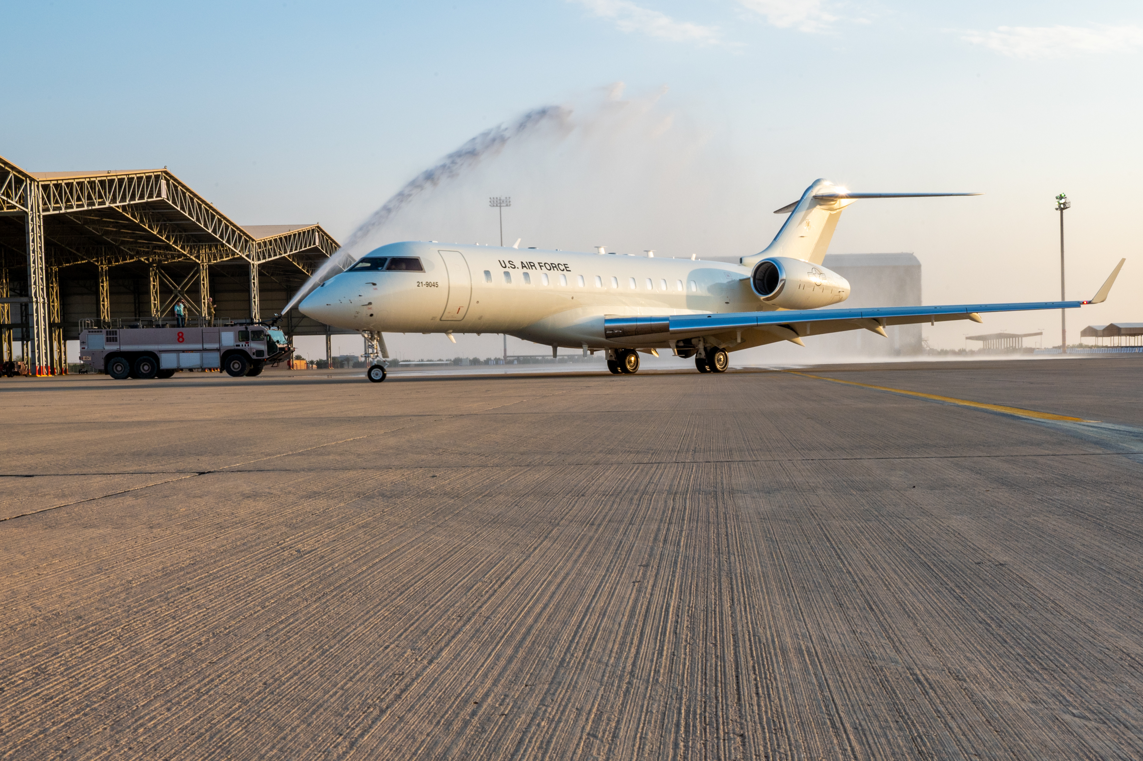 A new U.S. Air Force E-11A BACN aircraft taxis through a "bird bath" at Prince Sultan Air Base, Kingdom of Saudi Arabia, Dec. 16, 2022. This E-11A is the newest addition to 430th Expeditionary Electronic Communications Squadron's fleet. Commonly known as Battlefield Airborne Communications Node, or BACN, this aircraft extends the range of communications channels and enables better communication amongst units. (U.S. Air Force photo by Staff Sgt. Shannon Bowman)