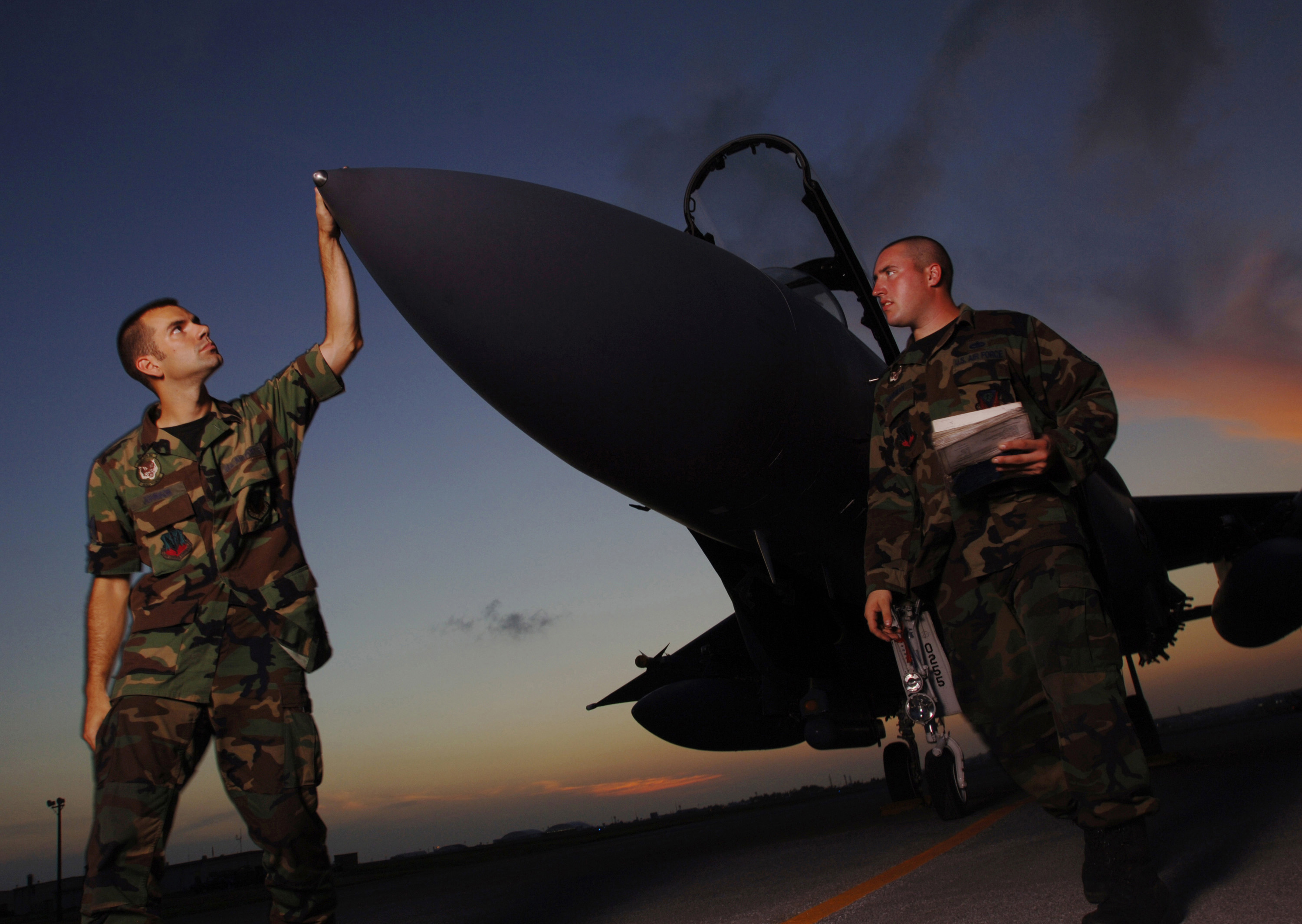 F-15 Eagle Crew Chiefs Staff Sgts. Andrew Johnson (left) and Brian Goodman inspect their aircraft on the flight line at Kadena Air Base, Japan, on Aug. 17, 2005. Johnson and Goodman are deployed to Kadena from the 391st Fighter Squadron, Mountain Home Air Force Base, Idaho, along with approximately 300 other Idaho airmen to support Pacific Command operations. (DoD photo by Master Sgt. Val Gempis, U.S. Air Force. (Released))