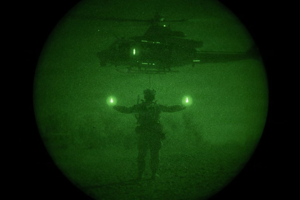A U.S. Airman assigned to 21st Special Tactics Squadron, 24th Special Operations Wing, Air Force Special Operations Command, guides a UH-1Y Venom during an assault basics exercise during Weapons and Tactics Instructor course 1-26 at K-9 Village, Yuma Proving Grounds, Arizona, Oct. 4, 2025. WTI is a seven-week training event hosted by MAWTS-1 which emphasizes operational integration of the six functions of Marine aviation in support of the Marine Air Ground Task Force, Joint and Coalition Forces. (U.S. Marine Corps photo by Lance Cpl. Christopher J. Castro)