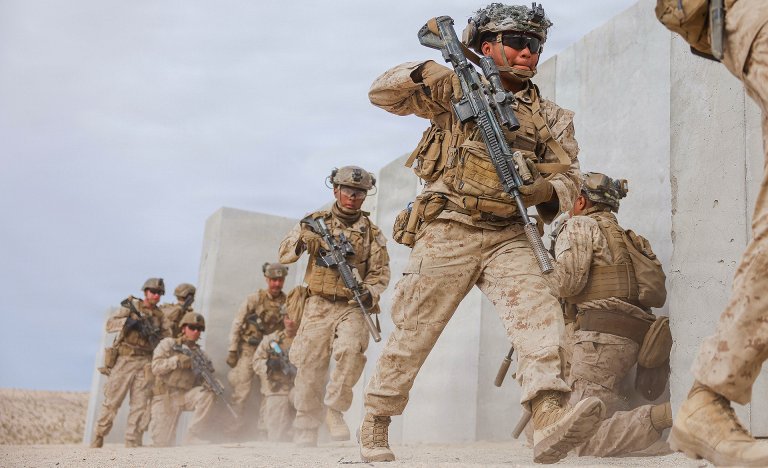 U.S. Marine Corps Cpl. Alexander PalafoxCayetano, a New York native, a transmission system operator with 1st Battalion, 2nd Marine Regiment, 2nd Marine Division, enters a building during urban lane training as part of service level training exercise 3-26 at Marine Corps Air Ground Combat Center, Twentynine Palms, California, April 6, 2026. Service level training exercise assesses Marine Air Ground Task Forces abilities to plan, coordinate and execute large-scale operations by integrating command and control, maneuver, sustainment and live-fire events in realistic training environments.  (U.S. Marine Corps photo by Lance Cpl. Parker Peichel)