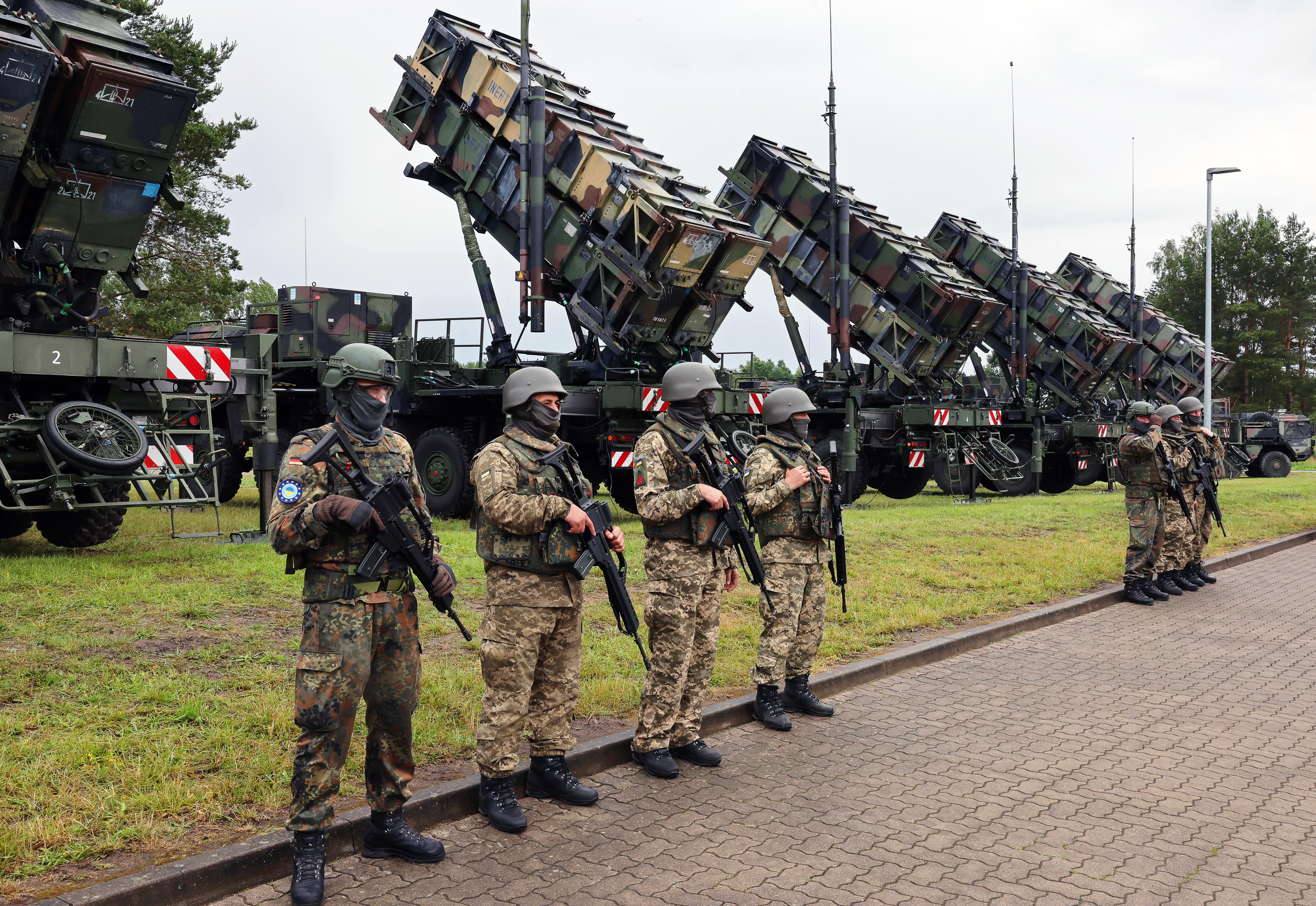 11 June 2024, Mecklenburg-Western Pomerania, ---: German and Ukrainian soldiers stand in front of "Patriot" anti-aircraft missile systems during the visit of Ukrainian President Zelenskyi to a military training area. The international reconstruction conference for Ukraine takes place on June 11 and 12. Photo: Jens Büttner/dpa (Photo by Jens Büttner/picture alliance via Getty Images)