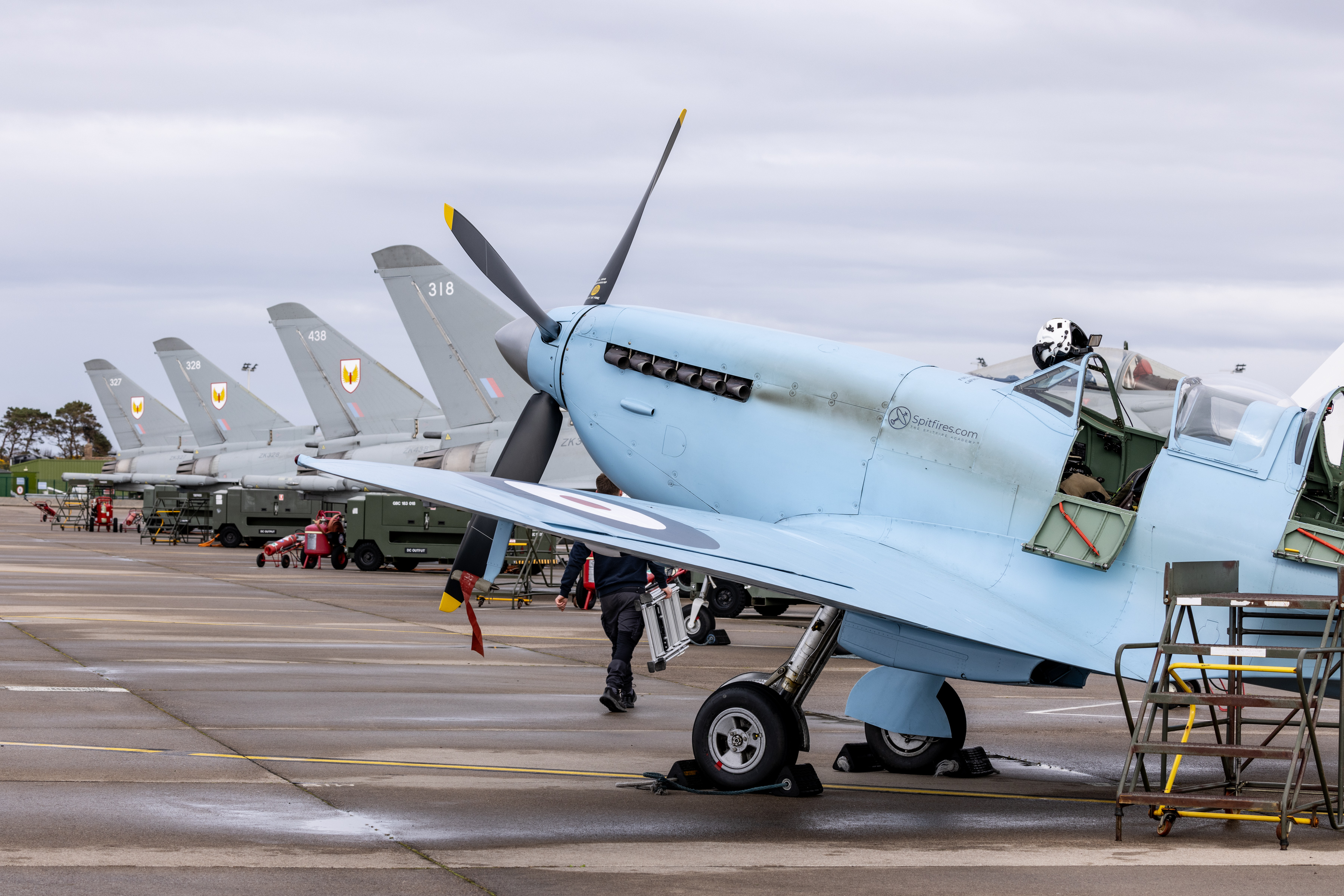 Image of a Spitfire and Typhoon aircraft seen here at RAF Lossiemouth as part of it's tour (Spitfire 90) around the United Kingdom. SPITFIRE 90 is a collaborative commemorative event between the Battle of Britain Memorial Flight (BBMF) and Spitfires.com. The Spitfire Academy. Marking 90 years since the first flight of the Spitfire prototype K5054 from Eastleigh Aerodrome on 5 March 1936, a specially painted twin-seat Spitfire TR9 will complete a nine-leg circumnavigation of Great Britain, with each leg representing a decade of the aircraft’s history. Operating from nine UK locations between 7 and 17 April 2026, the event coordinates with current RAF aircraft to demonstrate the evolution of air power, while raising funds for the RAF Benevolent Fund and the Mark Long Trust.
