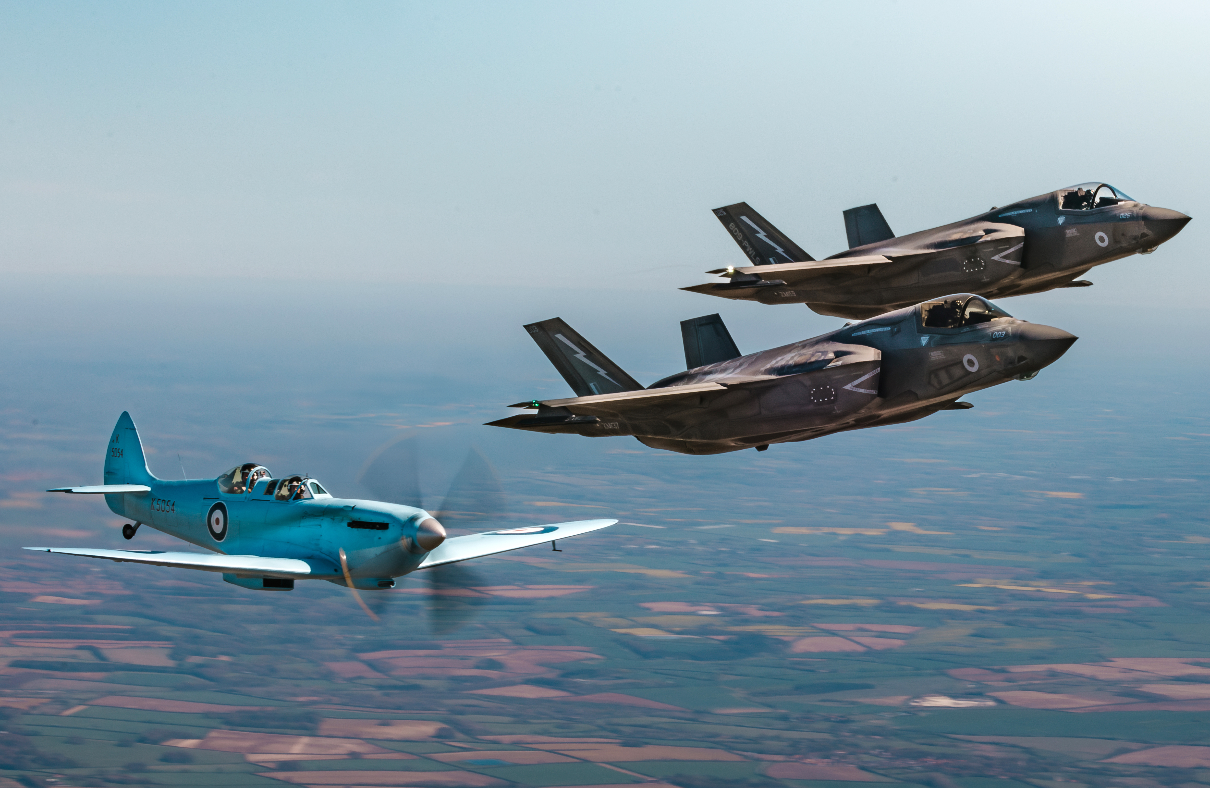 Image of Spitfire “K5054”, seen here alongside two F35 Lightning II Jets from RAF Marham as they transit to RAF Coningsby in the UK. The first flight of the eagerly anticipated commemorative Spitfire90 tour has successfully landed at RAF Coningsby. The nine flights have been organised to celebrate 90 years since the Supermarine Spitfire’s maiden flight. Departing from Southampton International Airport earlier today, the very site where Captain Joseph ‘Mutt’ Summers piloted the original Spitfire prototype K5054 on 5th March 1936, the specially painted two-seat Spitfire, replicating the original K5054, was escorted by the Dakota and Spitfire AB910 belonging to the Royal Air Force’s Battle of Britain Memorial Flight (BBMF) as it made its way to RAF Coningsby, the home of the BBMF. During the flight, "K5054" was also joined in the vicinity of RAF Marham by two F35 Lightning II aircraft.