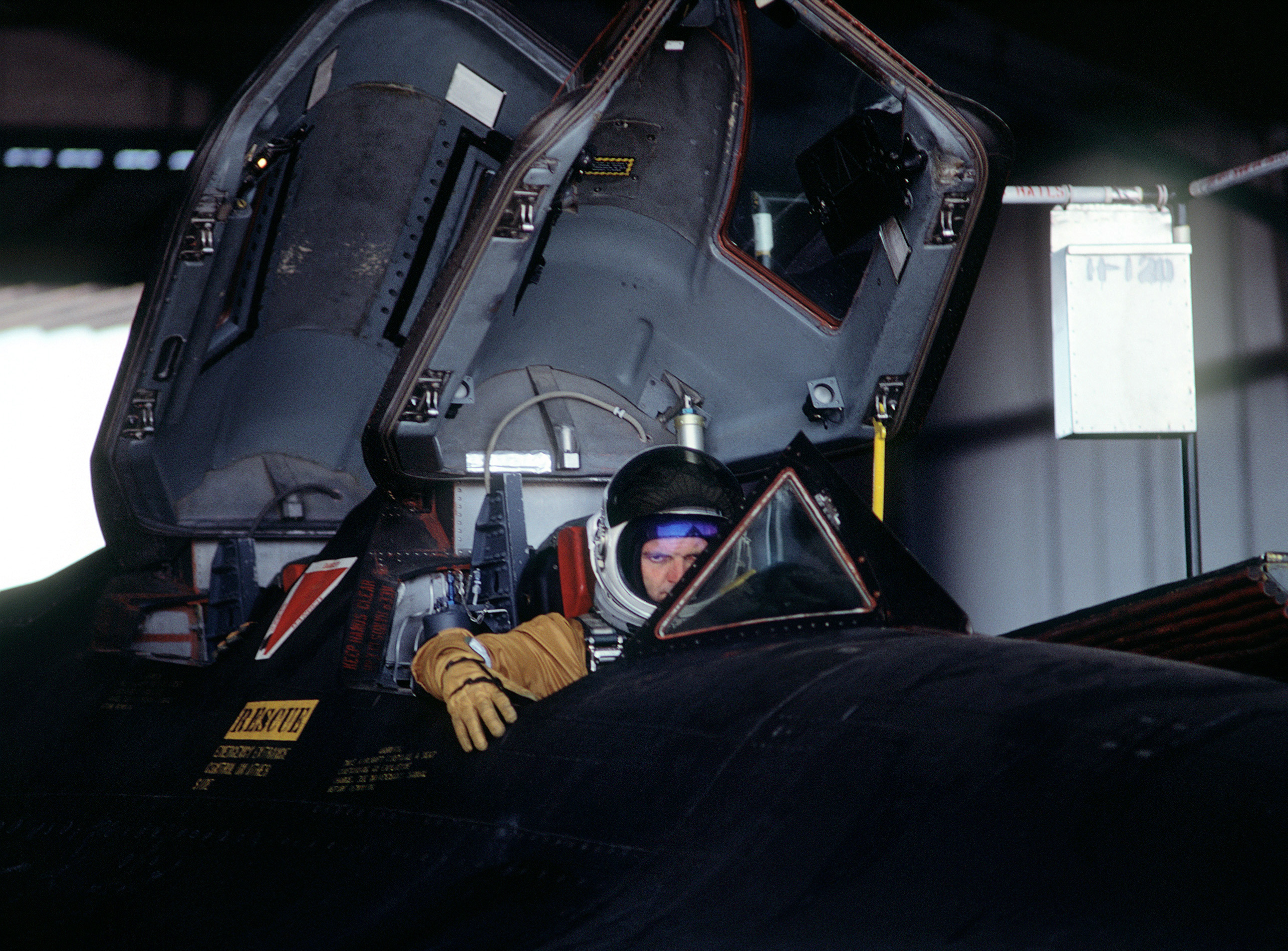 Pilots from the 9th Strategic Reconnaissance Wing sit in the cockpit of an SR-71 Blackbird aircraft prior to flight. The aircraft will be refueled by a KC-10 Extender aircraft while in flight during testing.