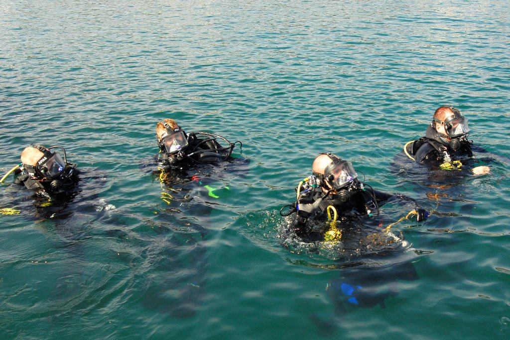 SAN DIEGO -- Crewmembers from Regional Dive Locker West prepare to dive underwater to inspect the hull of the Coast Guard Cutter Sea Otter, homeported here October 20. The Coast Guard recently created regional dive lockers and teams on both coasts capable of responding to apportioned or emergent operations. (U.S. Coast Guard photo by Petty Officer 3rd Class Melissa Hauck)