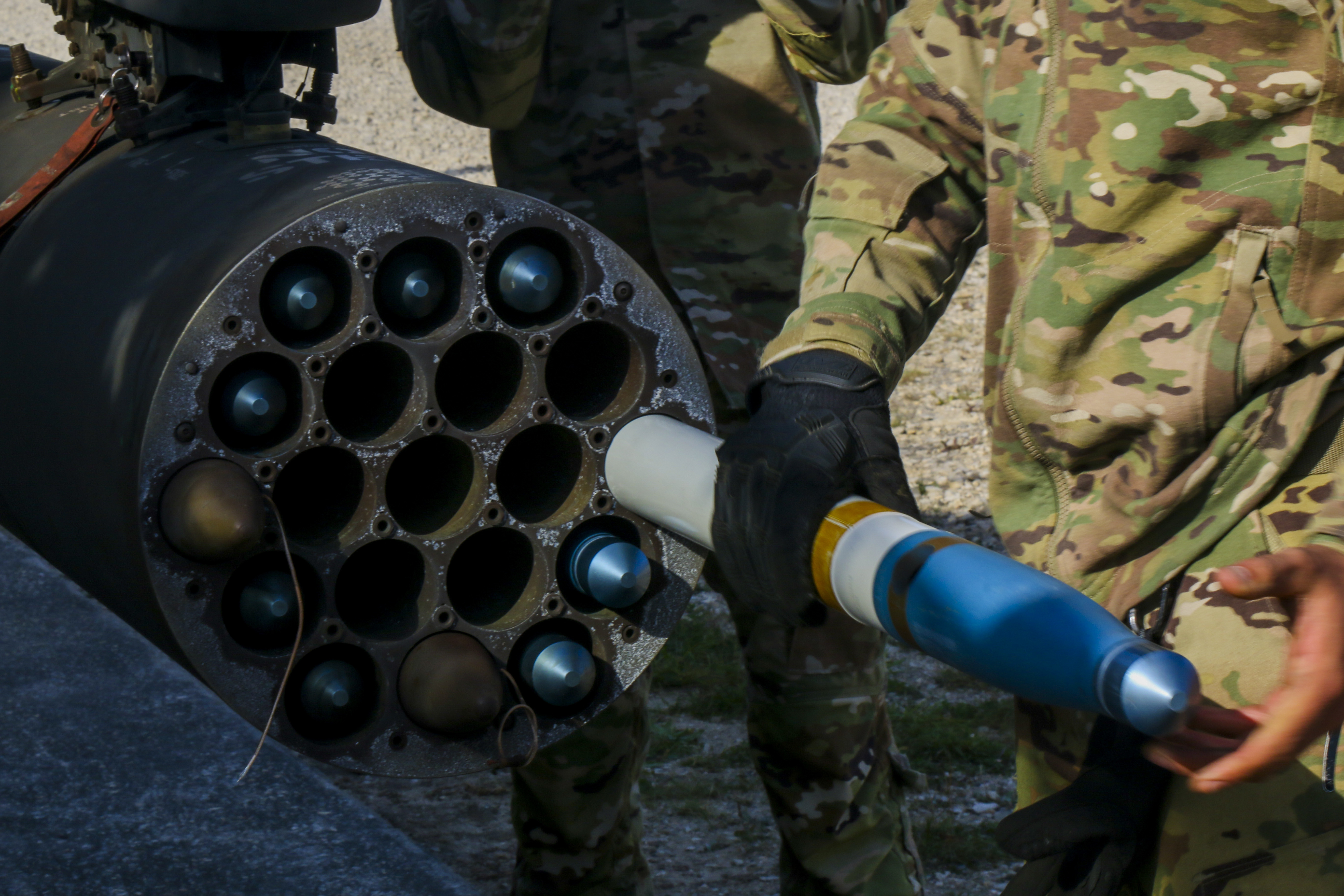 A U.S. Army Soldier assigned to the 12th Combat Aviation Brigade load an Advanced Precision Kill Weapon System (APKWS) training round for a live-fire exercise, Sept. 23, 2021, Grafenwoehr Training Area, Germany. The APKWS is the newest laser-guided rocket system utilized by the 12th CAB stationed throughout Europe. (U.S. Army photo by Pfc. Jesus Menchaca)