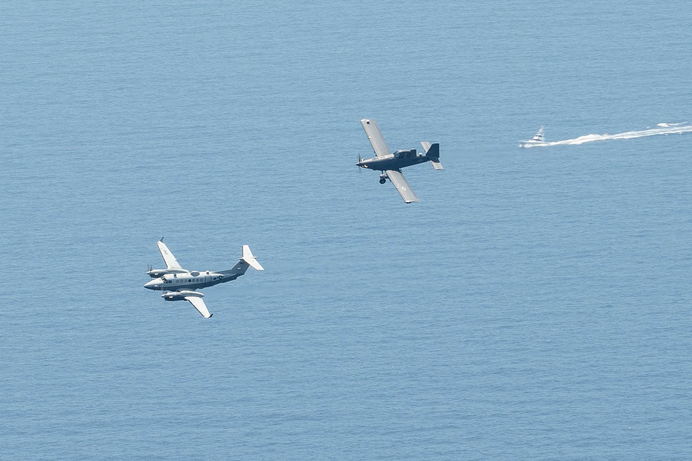 An OA-1K Skyraider II and an MC-12W Liberty fly over the Gulf of America near Hurlburt Field, Florida, June 6, 2025. The MC-12W Liberty’s real-time intelligence and surveillance capabilities complement the OA-1K Skyraider II’s precision strike support, making their collaboration a powerful asset to Air Force Special Operations Command’s mission. (U.S. Air Force photo by Airman 1st Class Tori Haudenschild)