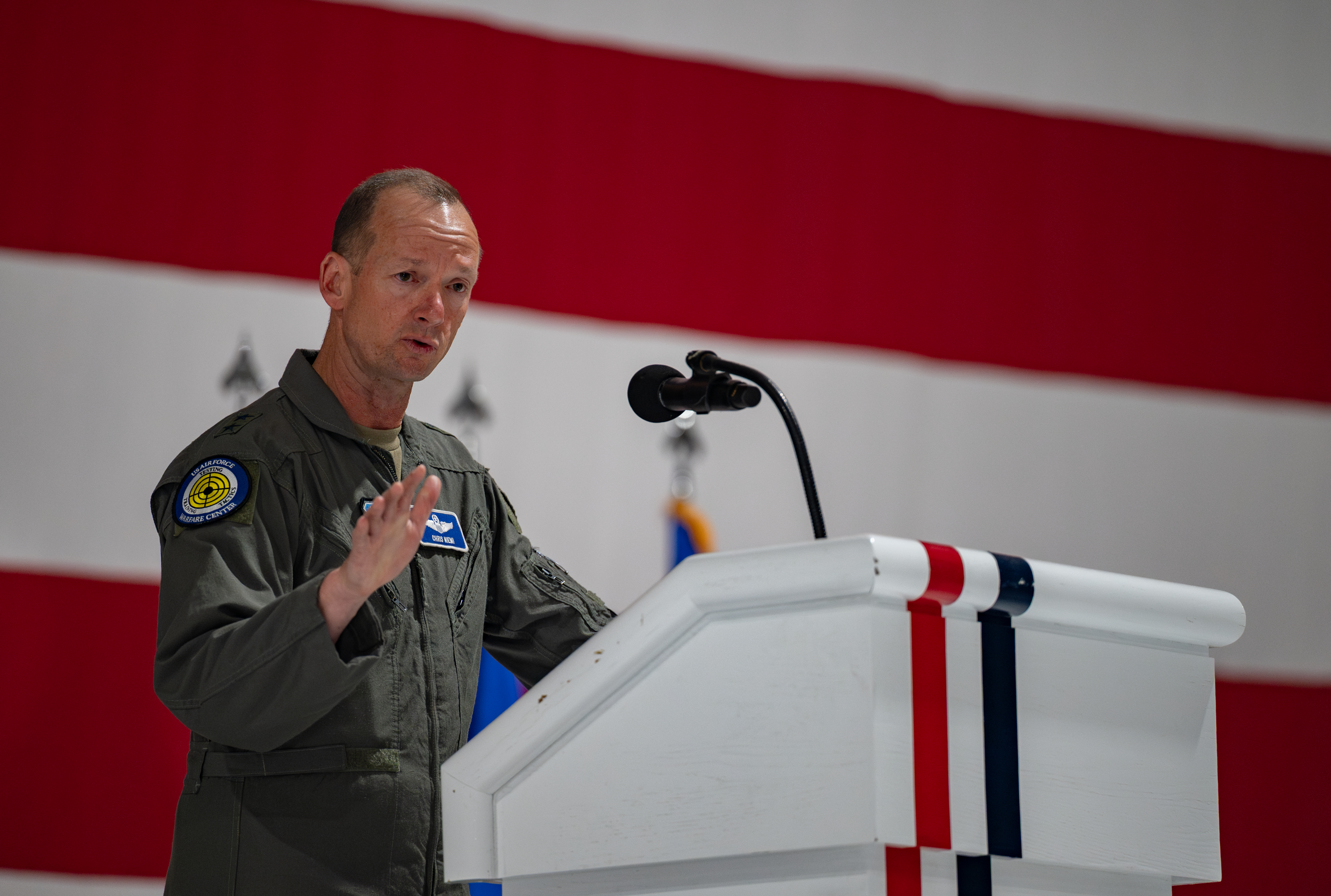 U.S. Air Force Maj. Gen. Christopher J. Niemi, U.S. Air Force Warfare Center commander, delivers opening remarks at the Nevada Test and Training Range (NTTR) change of command ceremony at Nellis Air Force Base, Nevada, June 9, 2025. The ceremony marks the transition of leadership, ensuring continuity in the NTTR’s mission to provide a dynamic, multidimensional battlespace for advanced training, testing and tactics development. (U.S. Air Force photo by Airman 1st Class Jennifer Nesbitt)