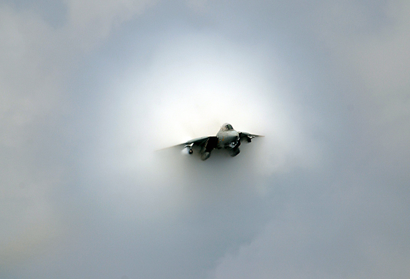A Navy F-14D Tomcat makes a near supersonic fly-by above the flight deck of the USS Theodore Roosevelt (CVN 71) during the final launch of Tomcats as the ship operates in the Atlantic Ocean on July 28, 2006. The F-14 will officially retire in September 2006 after 32 years of service to the fleet. This Tomcat is assigned to Fighter Squadron 31. (DoD photo by Petty Officer 3rd Class Nathan Laird, U.S. Navy. (Released))