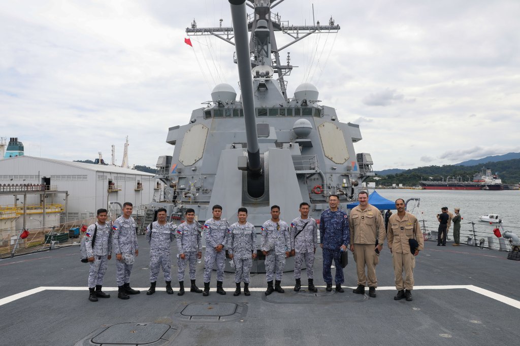 250911-N-CV021-1040 SUBIC BAY, Philippines (Sep. 11, 2025)—Sailors aboard the Arleigh Burke-class guided-missile destroyer USS John Finn (DDG 113), Sailors from the Philippine Navy and Cmdr. Noriyuki Kawahata, Assistant Defense Attaché of Japan to the Philippines, pose for a picture on the fo’c’sle during a subject matter exchange as part of the multi-lateral Maritime Cooperative Activity in Subic Bay, Philippines, Sep. 11. John Finn is forward-deployed and assigned to Destroyer Squadron (DESRON) 15, the Navy’s largest DESRON and the U.S. 7th Fleet’s principal surface force. (U.S. Navy photo by Mass Communication Specialist 2nd Class Alexandria Esteban)