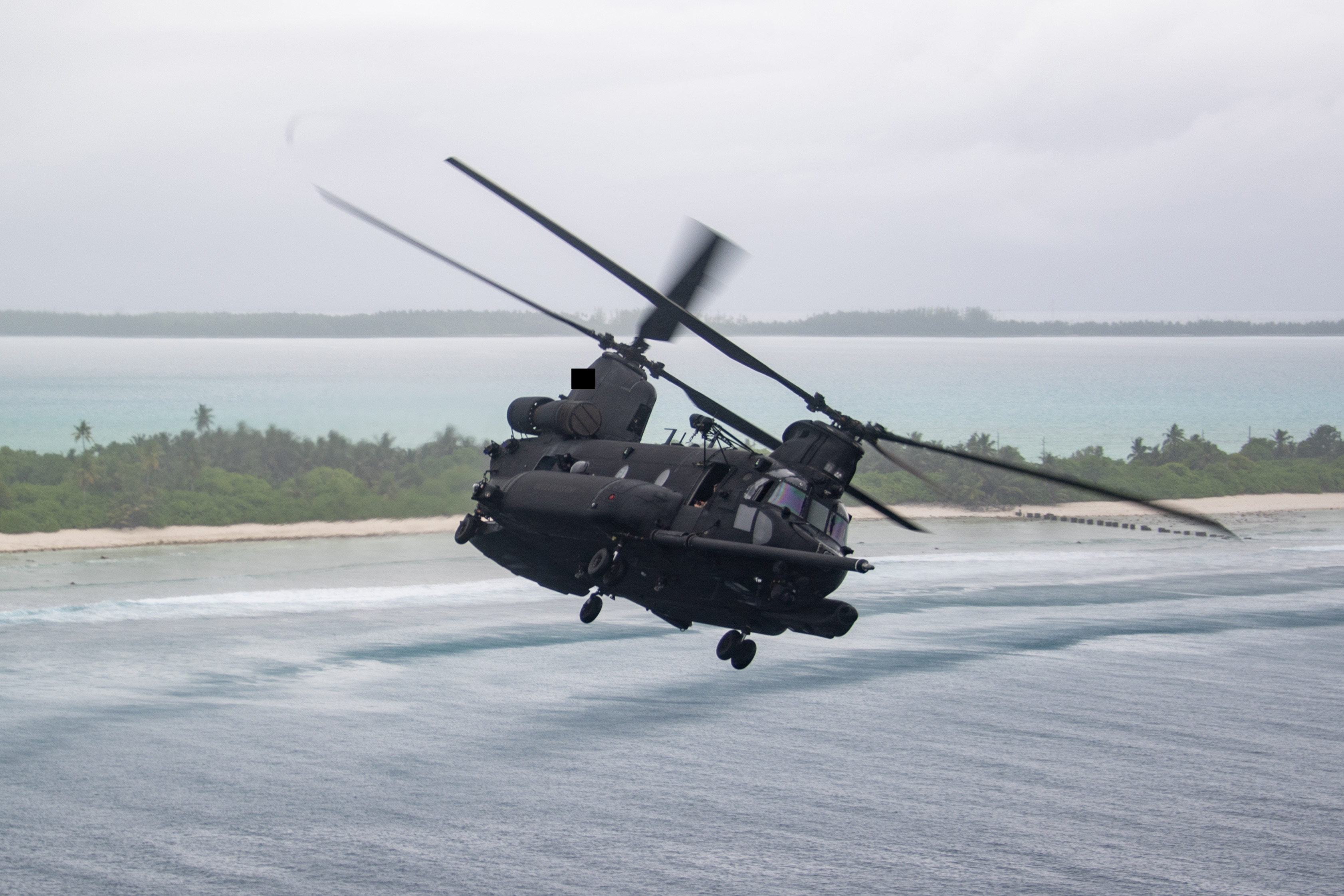 251014-N-ML137-1196 DIEGO GARCIA, British Indian Ocean Territory (Oct. 14, 2025) A MH-47G Chinook, attached to the “Night Stalkers” of U.S. Army 160th Special Operations Aviation Regiment, flies over Diego Garcia during a morale flight for service members stationed on the island, Oct. 14, 2025. U.S. Navy Support Facility Diego Garcia’s mission is to provide critical support to U.S. and allied forces forward deployed to the Indian Ocean, while supporting multi-theater forces operating in the CENTCOM, AFRICOM, EUCOM and PACOM areas of responsibilities in support of overseas contingency operations. (U.S. Navy photo illustration by Mass Communication Specialist 1st Class Samantha Jetzer)