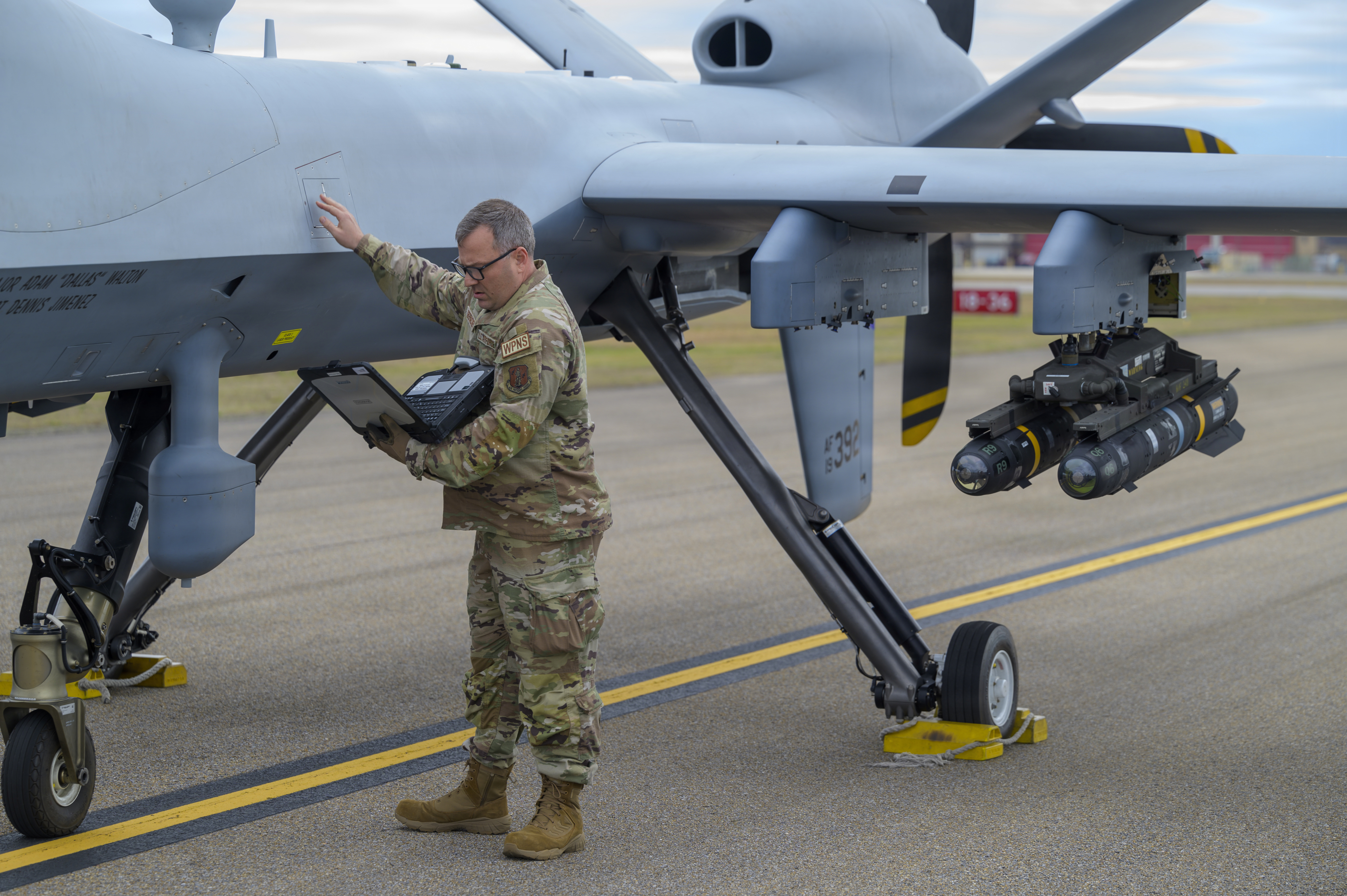 U.S. Air Force Tech. Sgt. Mark Oberacker, an aerospace ground equipment specialist assigned to the 174th Attack Wing, New York Air National Guard, checks data on the MQ-9 Reaper aircraft during exercise Sentry South 26-2 in Gulfport, Mississippi, March 3, 2026. Sentry South 26-2 is a large force employment exercise focused on major combat operations and joint maritime opportunities in a contested or degraded operational environment. Sentry South 26-2 applies joint and combined warfighting doctrine against realistic and robust enemy integrated threat systems, all while under safe and controlled conditions. (U.S. Air National Guard photo by Staff Sgt. Dylan McCrink)