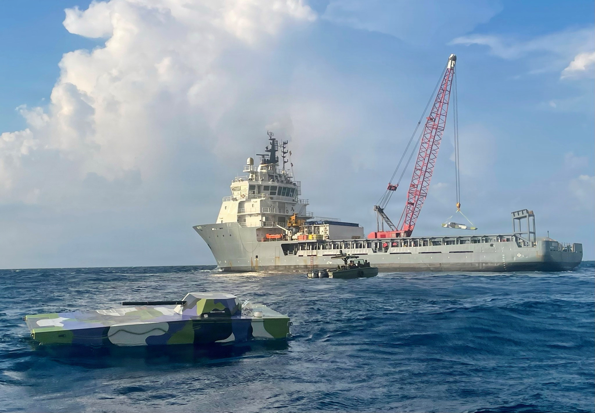 U.S. Indo-Pacific Command (USINDOPACOM) J7 Pacific Multi-Domain Training and Experimentation Capability (PMTEC) offloads a maritime drone target from U.S. Army ocean-contracted vessel MB480 in Palawan, Philippines, prior to the counter-landing live-fire exercise during Exercise Balikatan 2026 on April 27, 2026. The advanced unmanned maritime drone simulates an adversarial amphibious fighting vehicle. PMTEC provided maneuverable maritime and aerial targets to enable Philippine, Australian, New Zealand and U.S. forces to rehearse the full spectrum of detection, tracking, and engagement in a dynamic, contested environment. Balikatan is a longstanding annual exercise between the Armed Forces of the Philippines and U.S. military that represents the strength of our alliance, improves our capable combined force, and demonstrates our commitment to regional peace and prosperity. (Courtesy photo by Torch Technologies Inc., Philip Neveu)