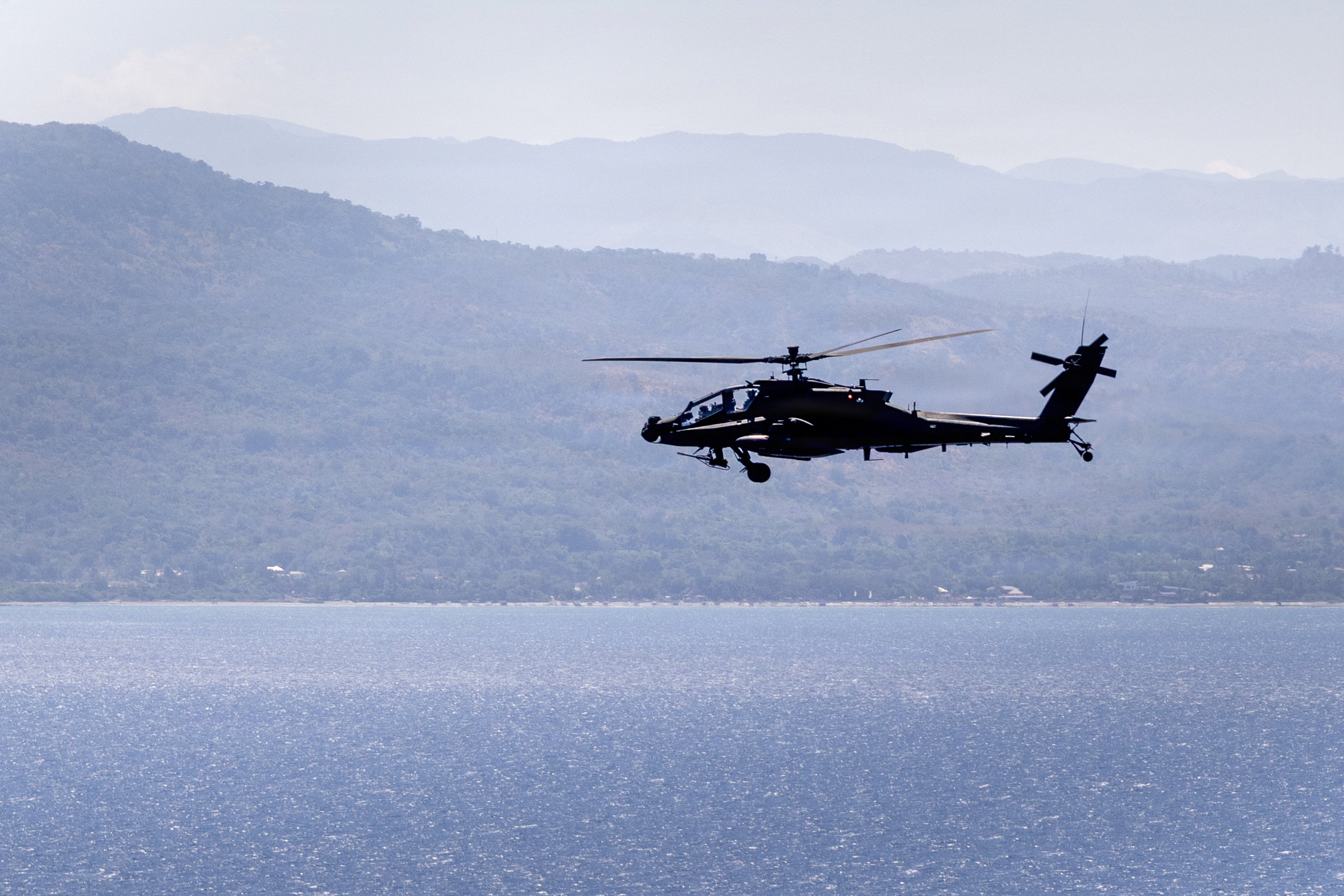 A U.S. Army AH-64 Apache helicopter assigned to Task Force Saber, 25th Combat Aviation Brigade, flies over open water during a counter landing live-fire exercise as part of Exercise Balikatan 2026 over the Luzon Strait, Philippines, May 4, 2026. Balikatan is a longstanding annual exercise between the Armed Forces of the Philippines and U.S. military that represents the strength of our alliance, improves our capable combined force, and demonstrates our commitment to regional peace and prosperity. (U.S. Army photo by Sgt. Olivia Cowart)