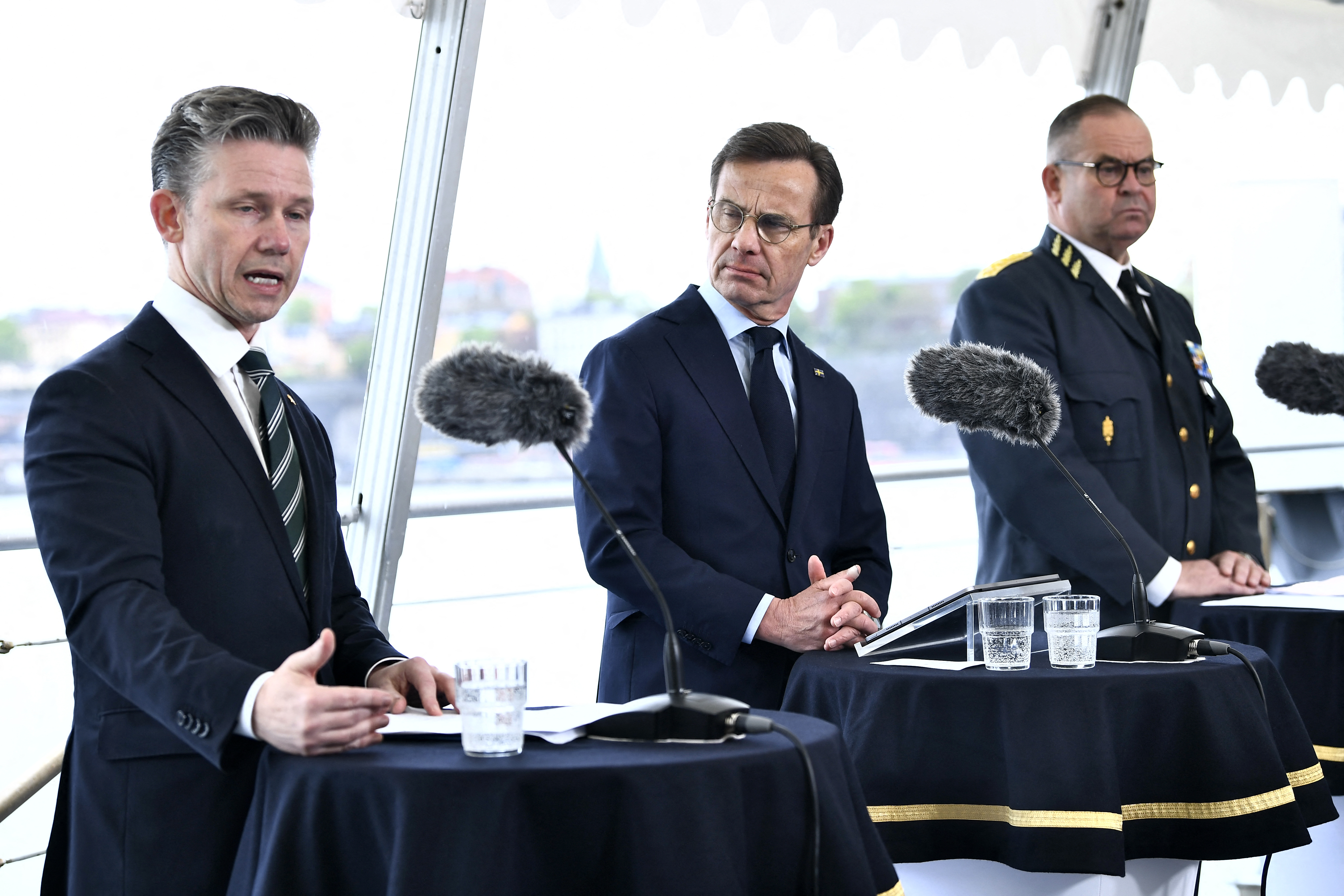 Sweden's Minister of Defence Paal Jonson, Sweden's Prime Minister Ulf Kristersson and Sweden's chief of Defence Staff and Supreme Commandant Michael Claesson deliver a press conference aboard the Visby-class corvette HMS Haernoesand in Stockholm, Sweden, on May 19, 2026. Sweden is moving forward with the French Naval Group as the armed forces prepare to acquire their largest and most expensive warships in decades. Sweden is set to purchase four FDI-type frigates. (Photo by Lars SCHRODER / TT News Agency / AFP via Getty Images) / Sweden OUT