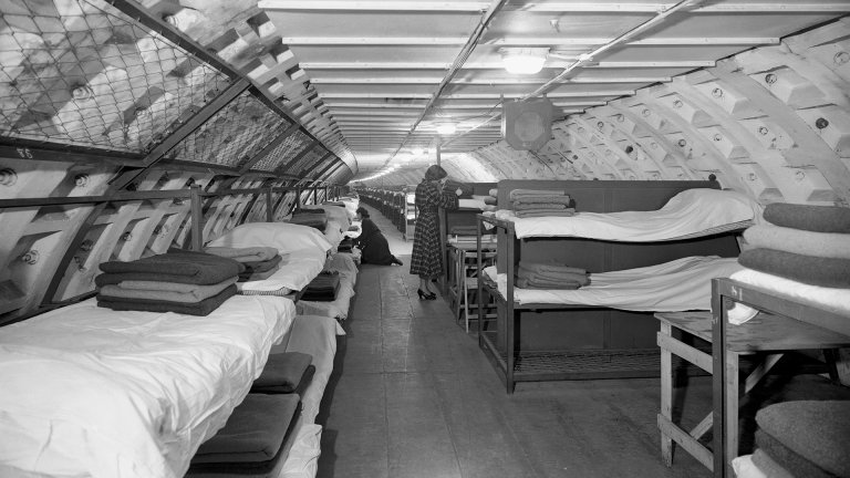 Sleeping accommodation in the Clapham deep shelter, London. Four thousand beds at three shillings a night, deep beneath London, are being offered to Festival of Britain visitors. The beds, together with dining accommodation, are in Clapham's deep shelter, now taken over by the London County Council. The deep shelter is a mile long, runs 45 feet beneath the underground railway. (Photo by PA Images via Getty Images)