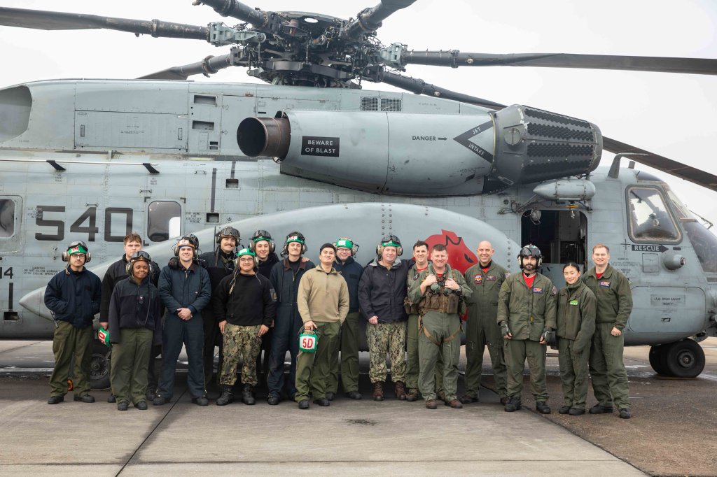 Sailors assigned to the “Vanguard” of Helicopter Mine Countermeasures Squadron 14 (HM-14) posed for a photo in front of an MH-53 “Sea Dragon” helicopter prior to the squadron’s last flights Dec. 8, 2022. (U.S. Navy photo by Mass Communication Specialist 2nd Class Malachi Lakey)