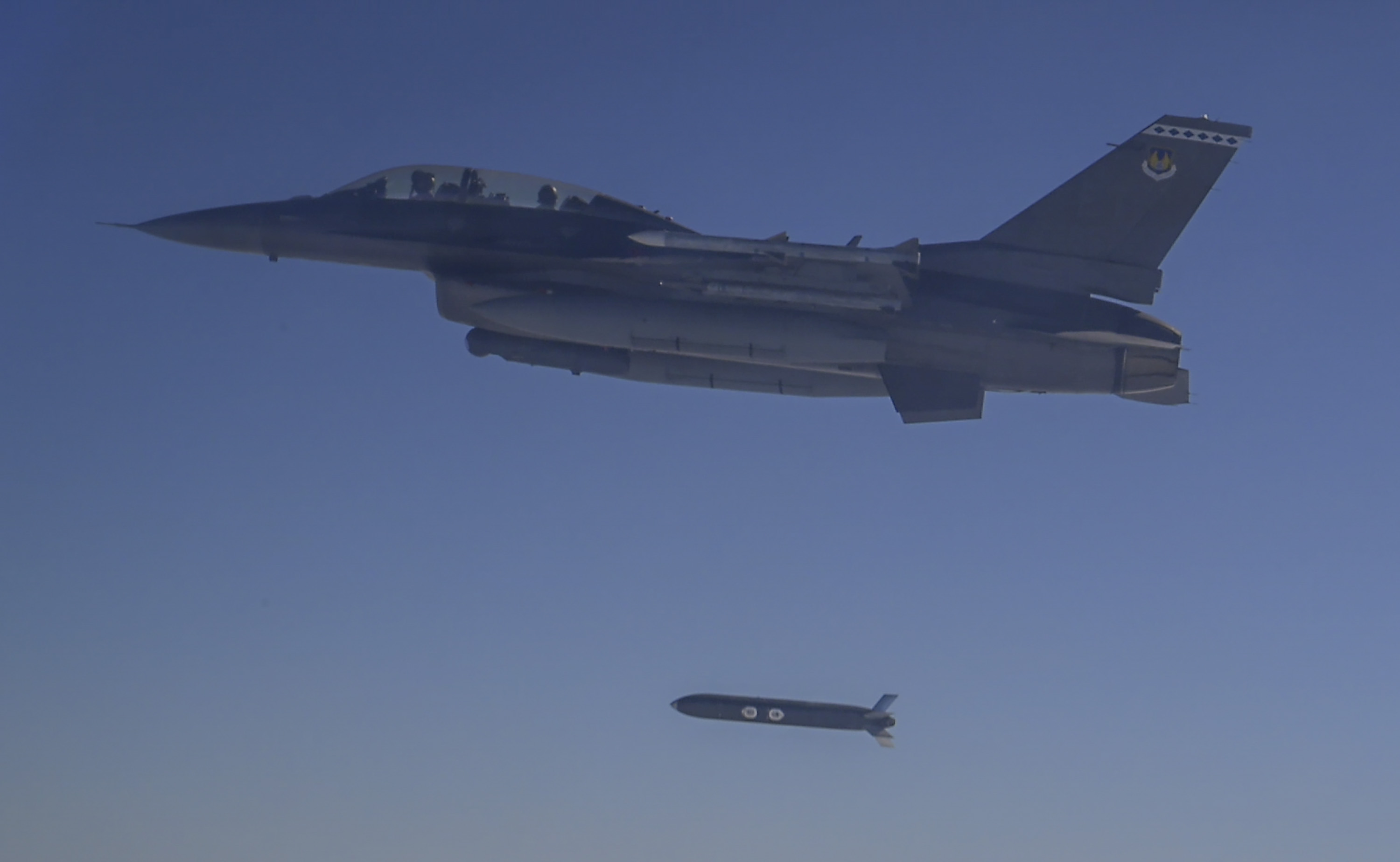 A U.S. Air Force F-16 Fighting Falcon releases a Family of Affordable Mass Munition – Lugged weapon over the Gulf of America. This release was part of a rapid test series performed by the 96th Test Wing and 53rd Wing. (U.S. Air Force photo by Staff Sgt. Blake Wiles)