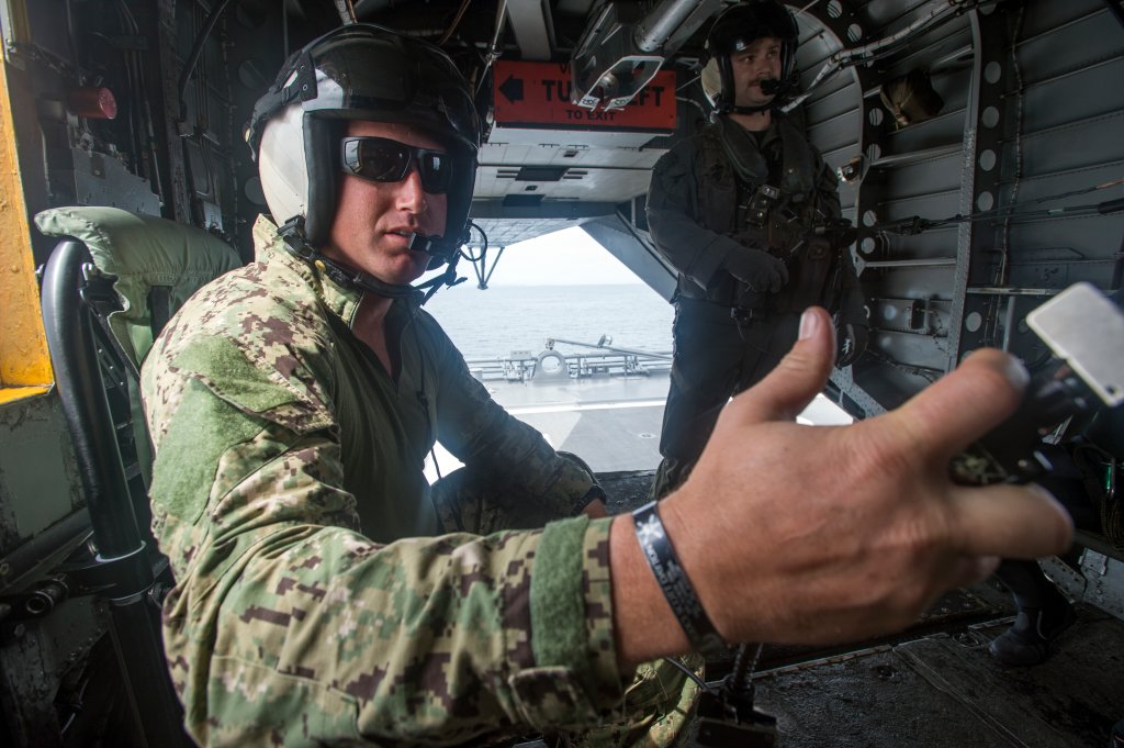An explosive ordnance disposal technician, assigned to Explosive Ordnance Disposal Mobile Unit 5 Platoon 502, operates a communications system aboard an MH-53 helicopter belonging to Helicopter Mine Countermeasures Squadron (HM) 14 during the 2JA Mine Countermeasure Exercise (2JA MCMEX) in Japan’s Mutsu Bay July 24, 2017. 2JA MCMEX is an annual bilateral exercise between the U.S. Navy and Japan Maritime Self-Defense Force to strengthen interoperability and increase proficiencies in mine countermeasure operations. (U.S. Navy Combat Camera photo by Mass Communication Specialist 2nd Class Alfred A. Coffield)