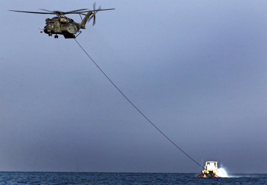 An MH-53E Sea Dragon from Helicopter Mine Countermeasure Squadron (HM) 15, aboard the multipurpose amphibious assault ship USS Wasp (LHD 1), performs Mine Countermeasure training using the MK-105 sled Nov. 12. Wasp is conducting Mine Countermeasure Exercises to demonstrate the U.S. Navy's ability to defend against mine-laying operations and ensure open access to sea lanes. (U.S. Navy photo/Lt. Cmdr. John L. Kline)
