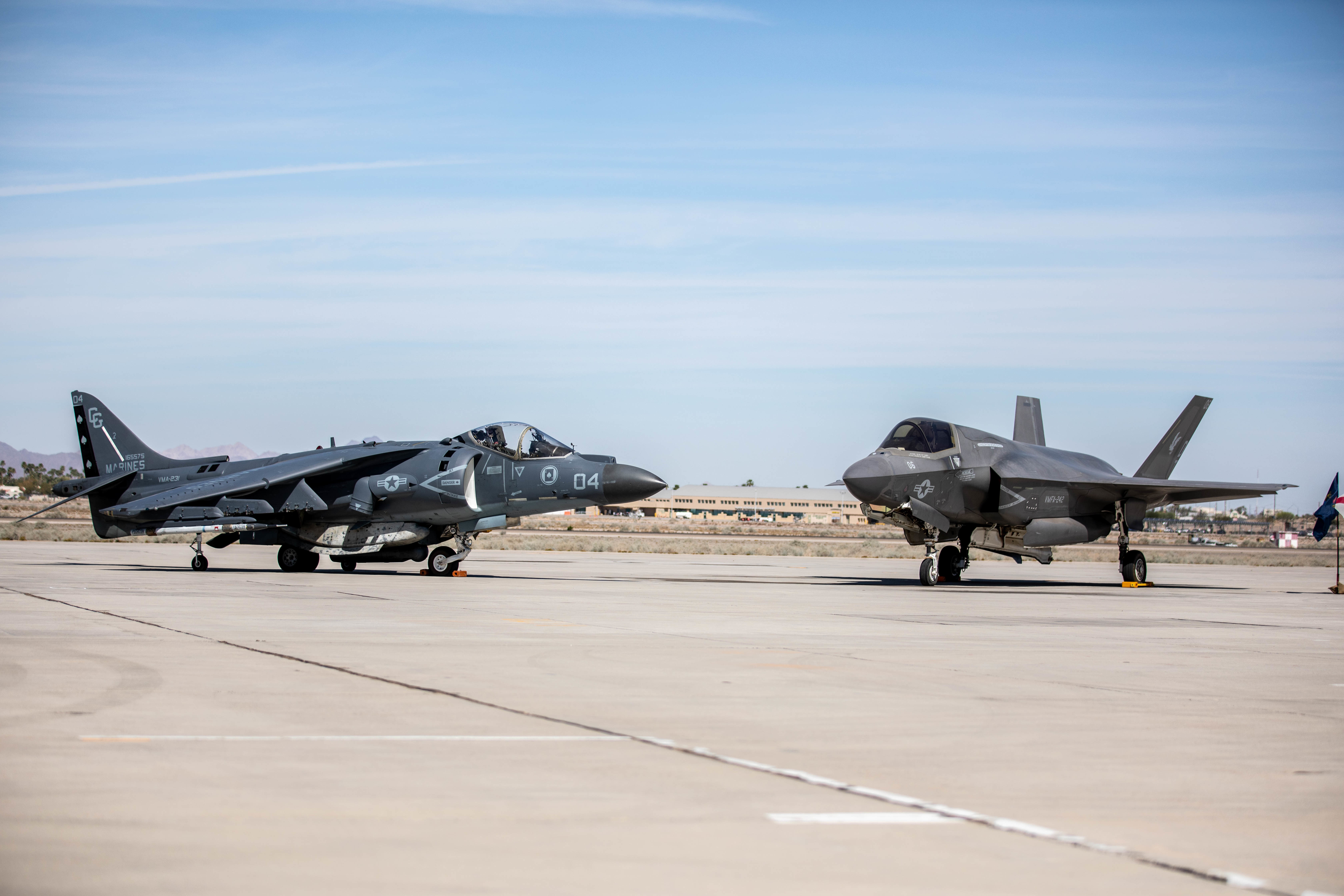 An AV-8B Harrier and an F-35B Lightning II are staged during the change of command and redesignation ceremony for Marine Fighter Attack Squadron (VMFA) 214 aboard Marine Corps Air Station Yuma, Arizona, March, 25, 2022. As part of the transition from the AV-8B Harrier to the F-35B Lightning II, Marine Attack Squadron 214 was re-designated as VMFA-214. The F-35B Lightning II is replacing the AV-8B Harrier to introduce unmatched capabilities to the Marine Corps. The F-35B Lightning II represents a leap forward in air dominance by providing the operational agility and tactical supremacy Marines need to provide expeditious and lethal support.(U.S. Marine Corps photo by Sgt. Samuel Ruiz)