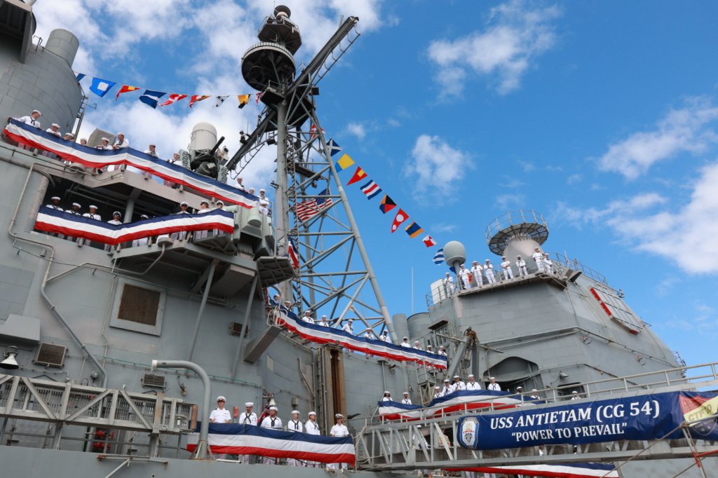 HONOLULU (September 27, 2024) – Crewmembers prepare to say farewell to their ships during the decommissioning ceremony of Ticonderoga-class guided-missile cruiser USS Antietam (CG 54). Commissioned in Baltimore, Maryland on May 22, 1987, Antietam completes its service after 37 years. Modern U.S. Navy guided-missile cruisers perform multiple mission including Air Warfare (AW), Undersea Warfare (USW), Naval Surface Fire Support (NSFS) and Surface Warfare (SUW) surface combatants capable of supporting carrier battle groups, amphibious forces or operating independently and as flagships of surface action groups. (U.S. Navy photo by Ens. Paula Hackbart/Released)